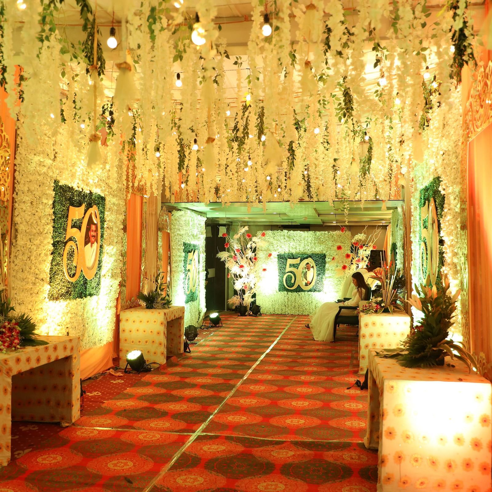Entrance hall featuring draped fabrics, lighting, and seating arrangements at Hotel Ashok Nagpur.