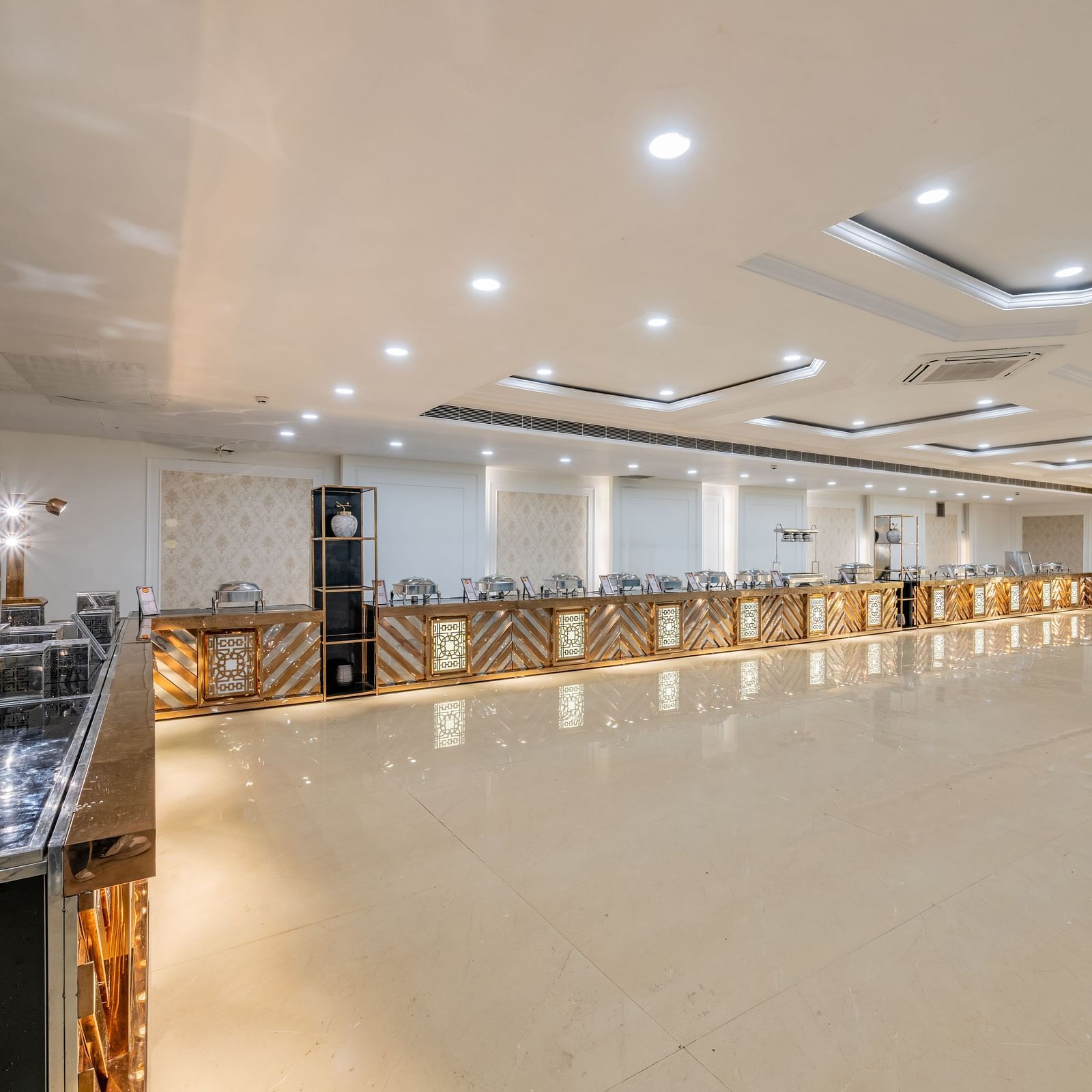 Well-lit event hall with buffet counter setup at Hotel Highway King, Bilaspur.