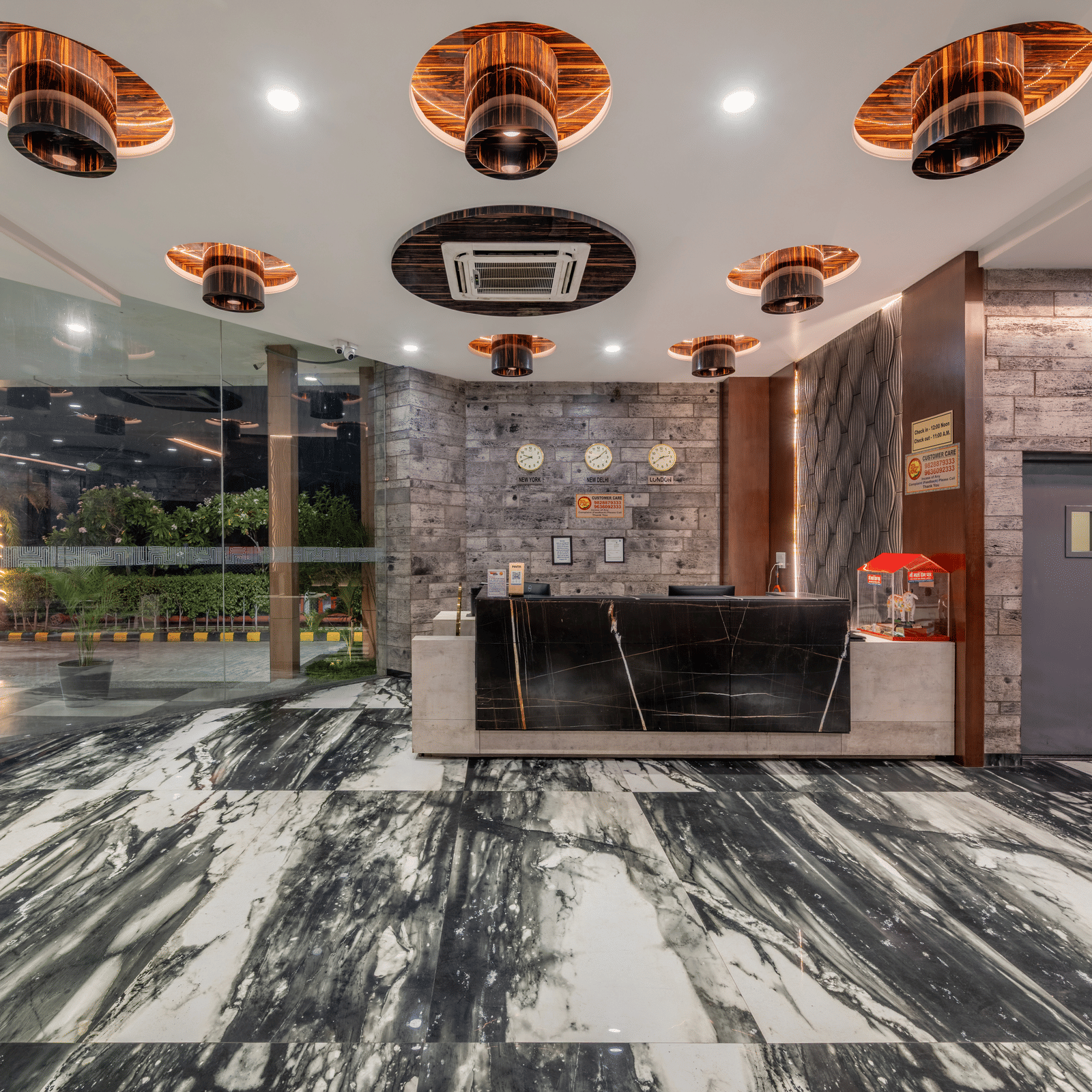 Reception area with black marble desk and contemporary decor at Hotel Highway King, Bilaspur.