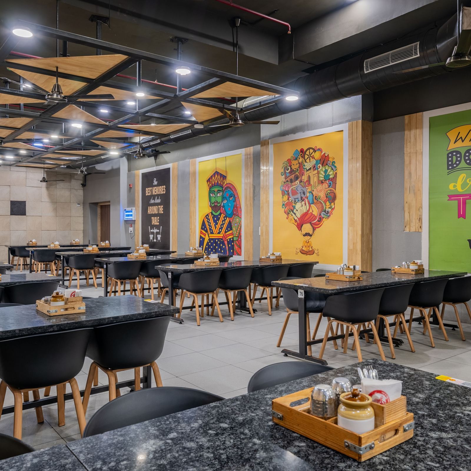 Spacious dining area with vibrant wall murals at Hotel Highway King restaurant.