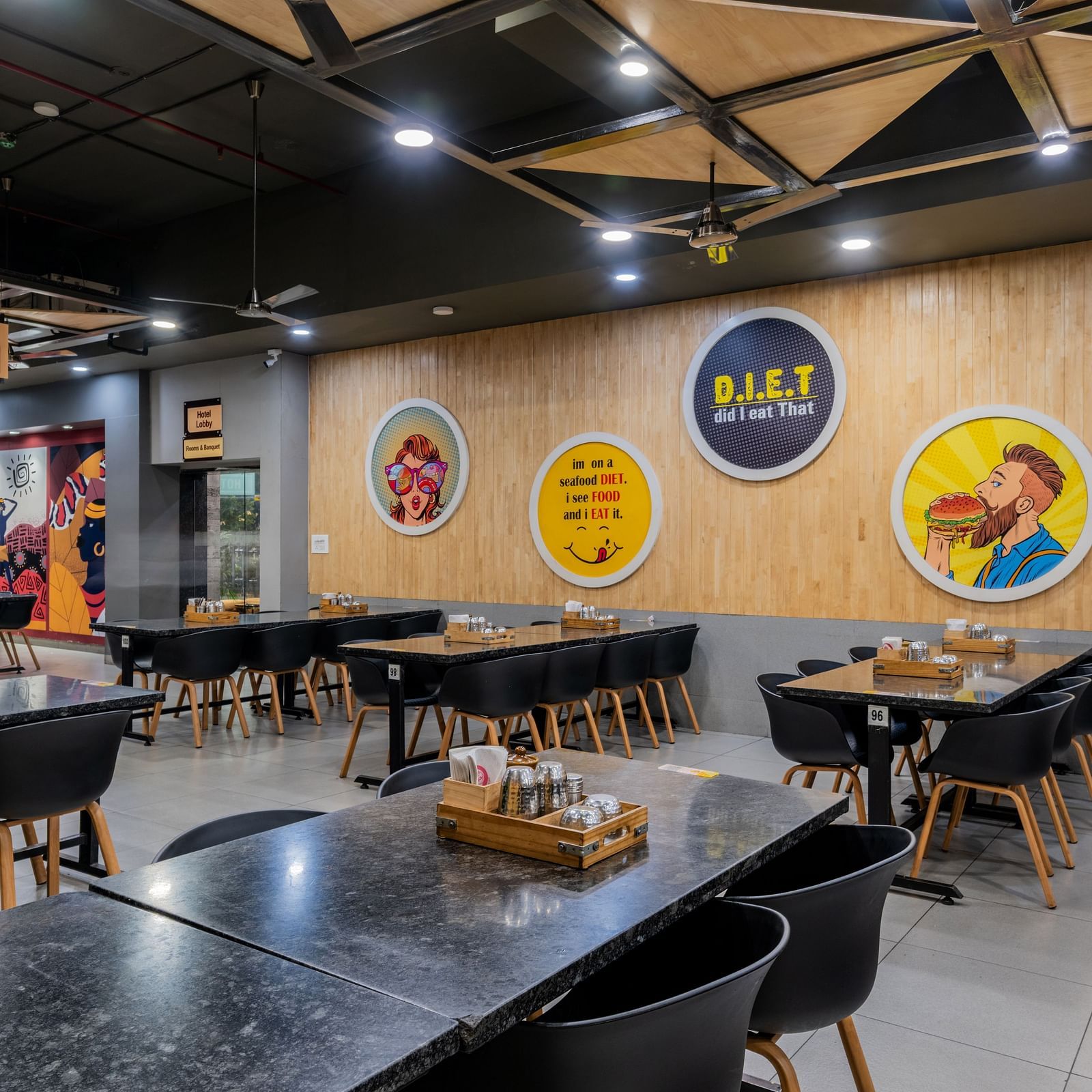 Modern casual dining section with warm lighting near the food counter at Hotel Highway King, Bilaspur.