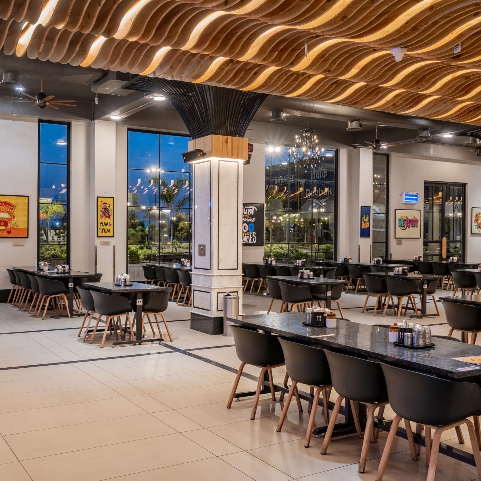 The dining space at Hotel Highway King, Kishangarh, with its distinctive ceiling and well-arranged furniture.