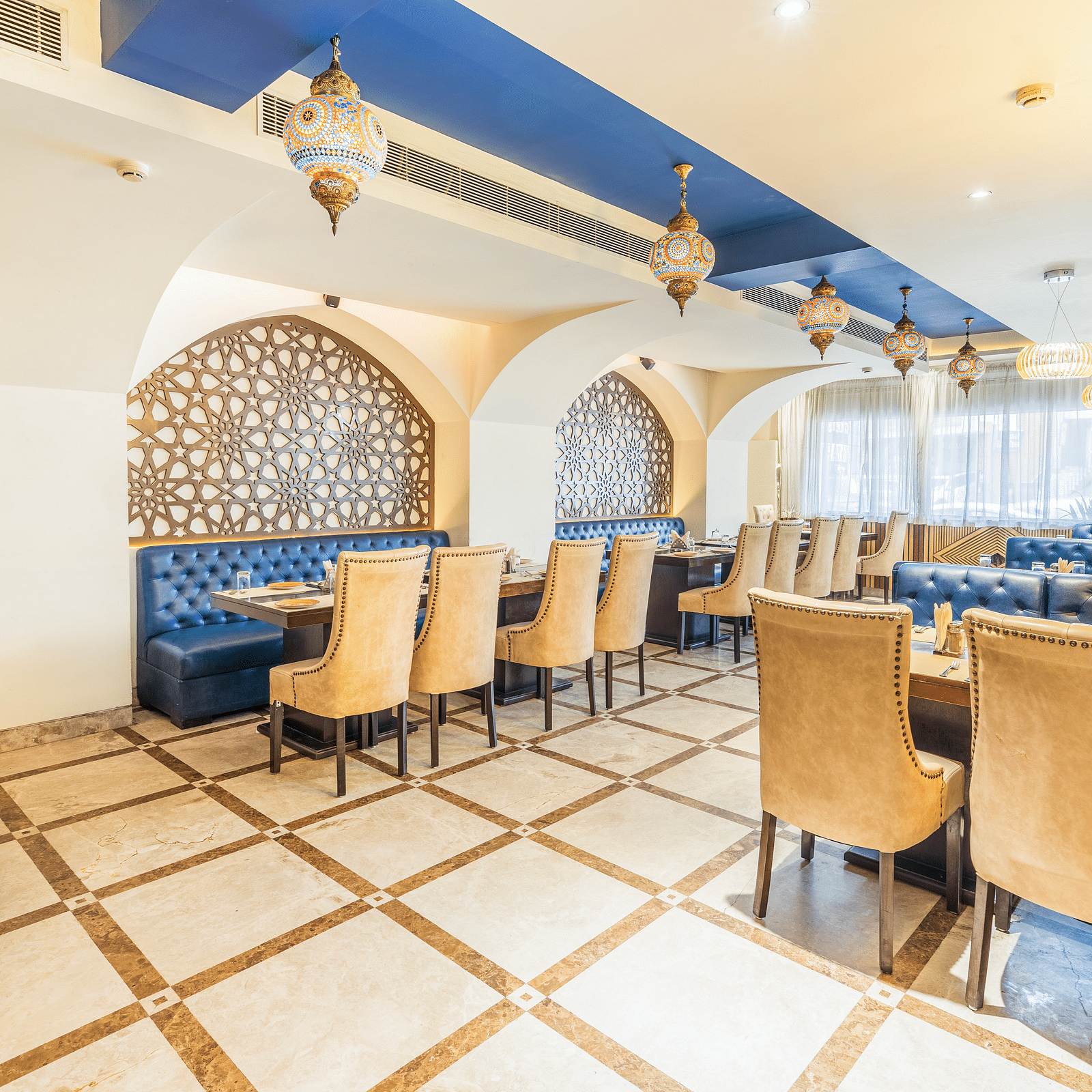A side angle view of the restaurant and along with comfy chairs and tableHotel Moti palace .
