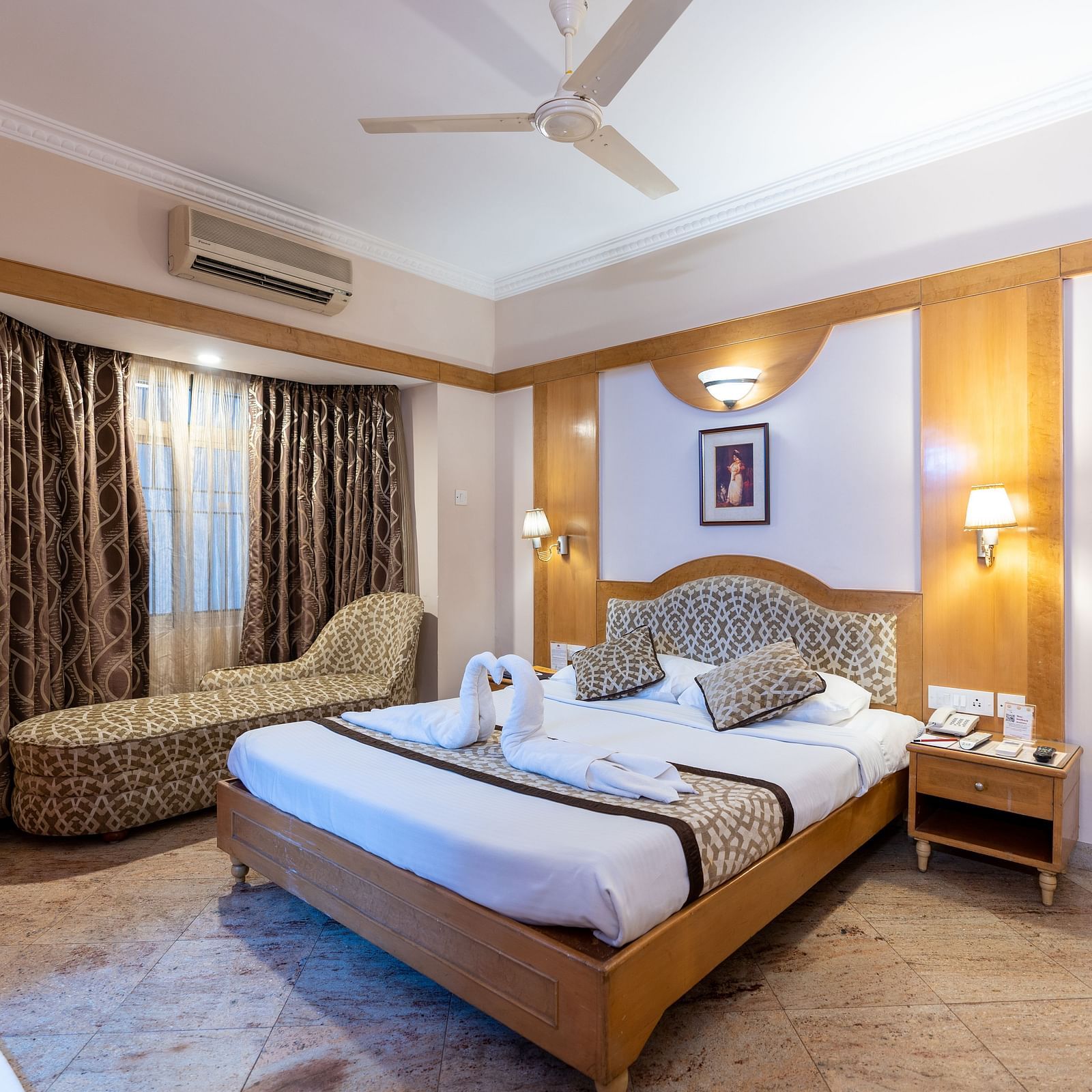 a double bed with a lamp above it inside one of the rooms - Hotel Pai Comforts, JP Nagar