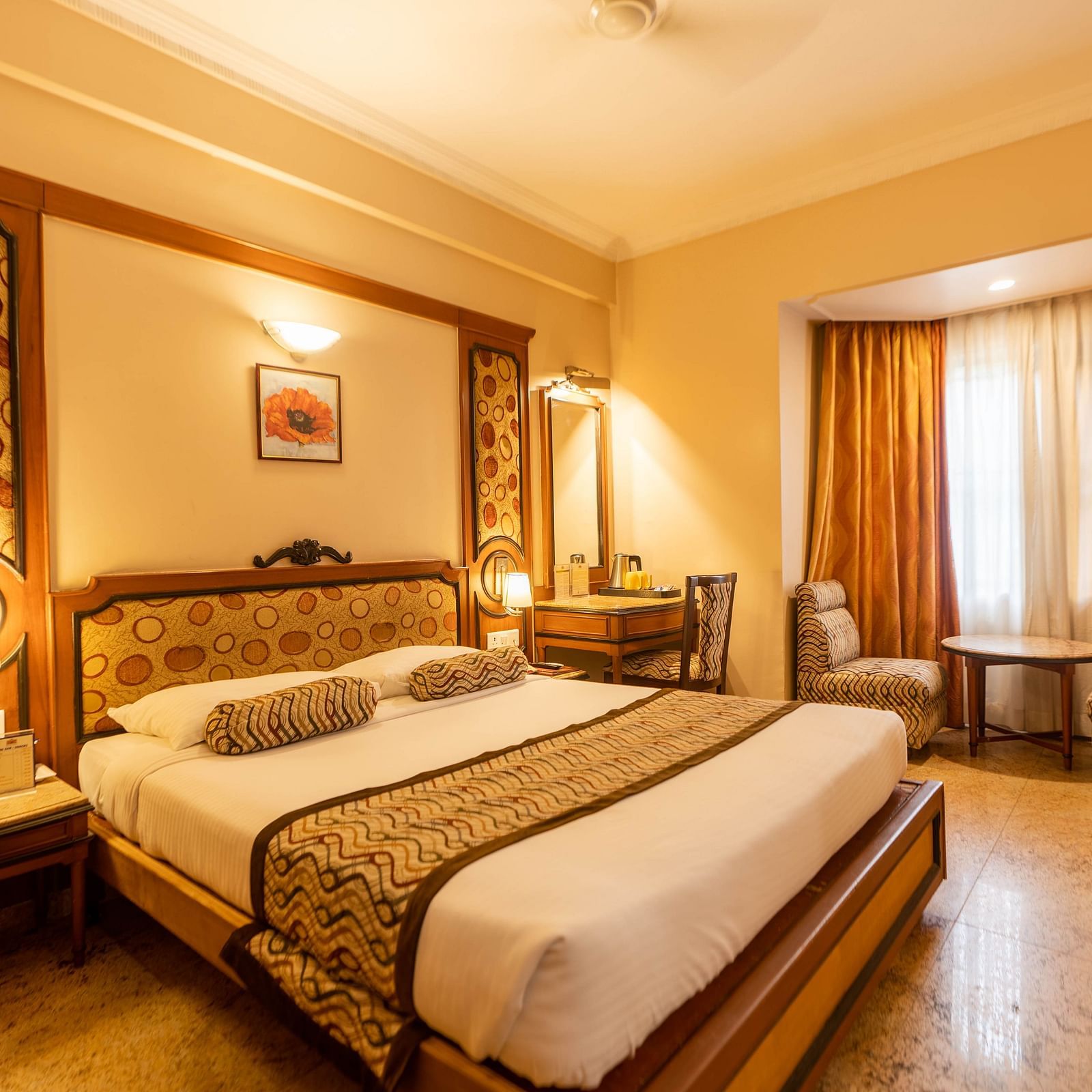 The Executive Room at Hotel Pai Viceroy Jayanagar featuring warm interiors and a queen sized bed amongst other amenities