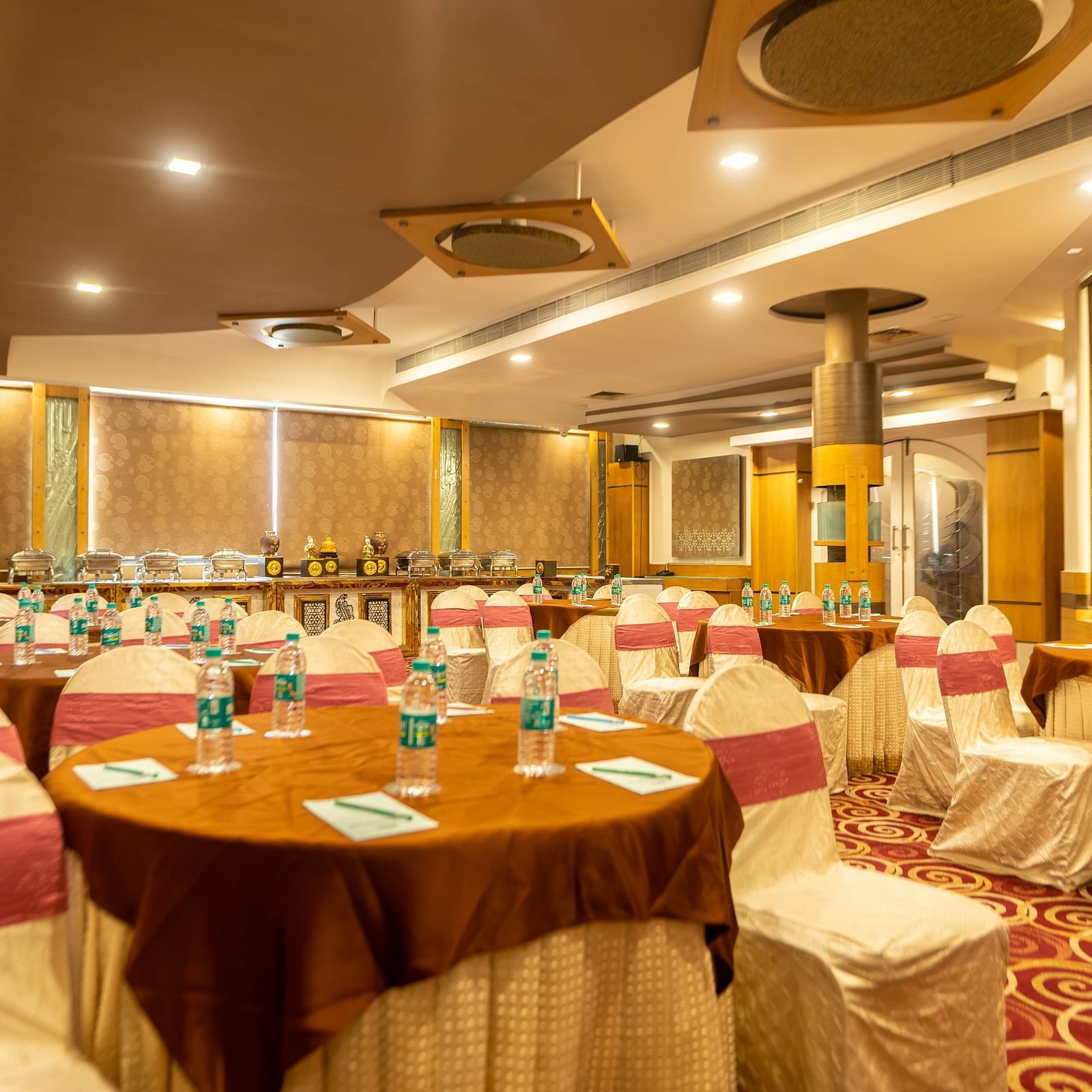 A banquet hall at Hotel Pai Viceroy Jayanagar in a wedding setup featuring ambient lighting