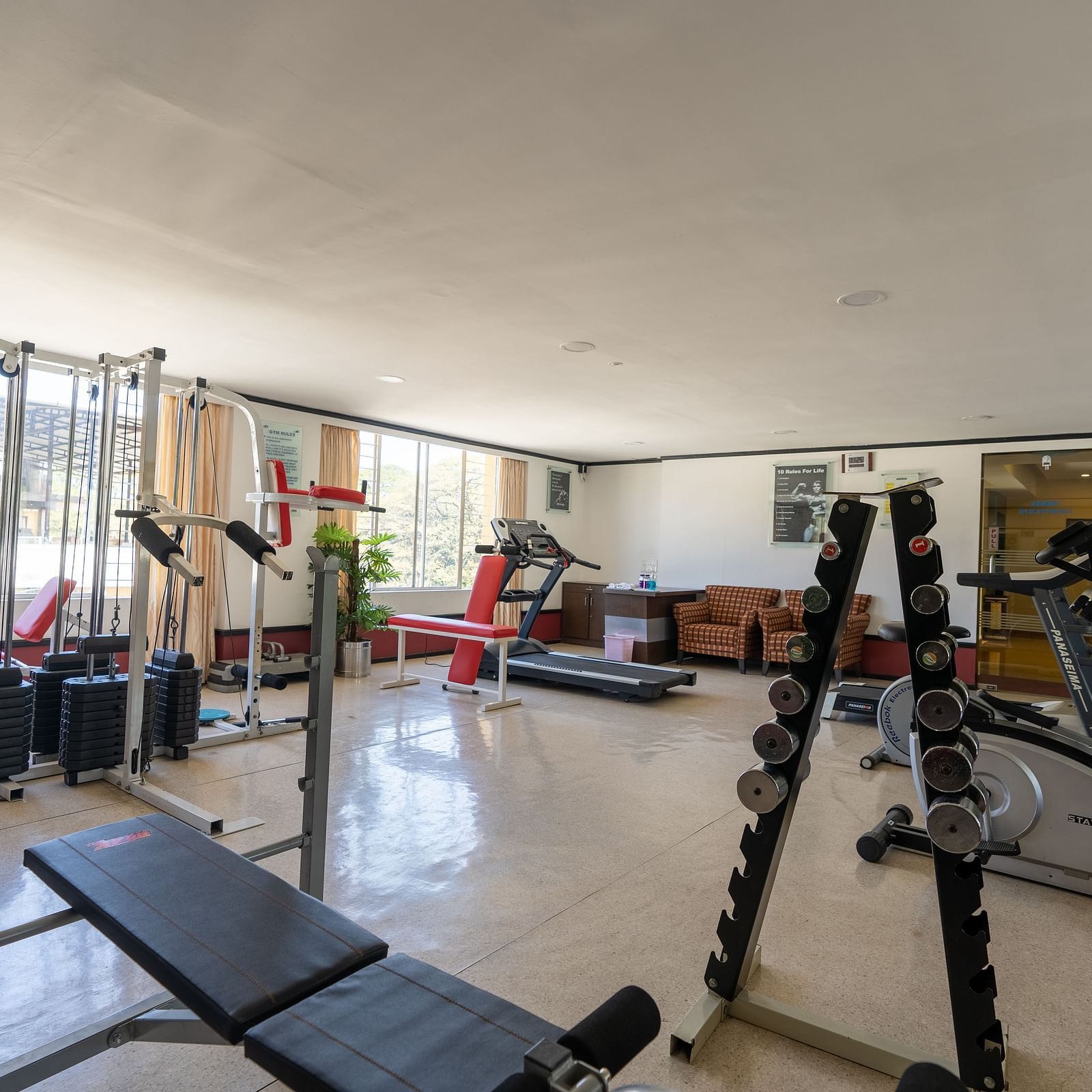 overview of the gymnasium with modern equipment inside - Hotel Pai Vista, Mysore