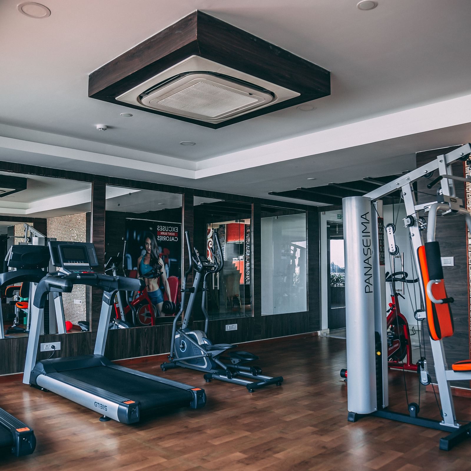 a gym with a treadmill  and other gym equipment - Hotel Park Elanza, Chennai