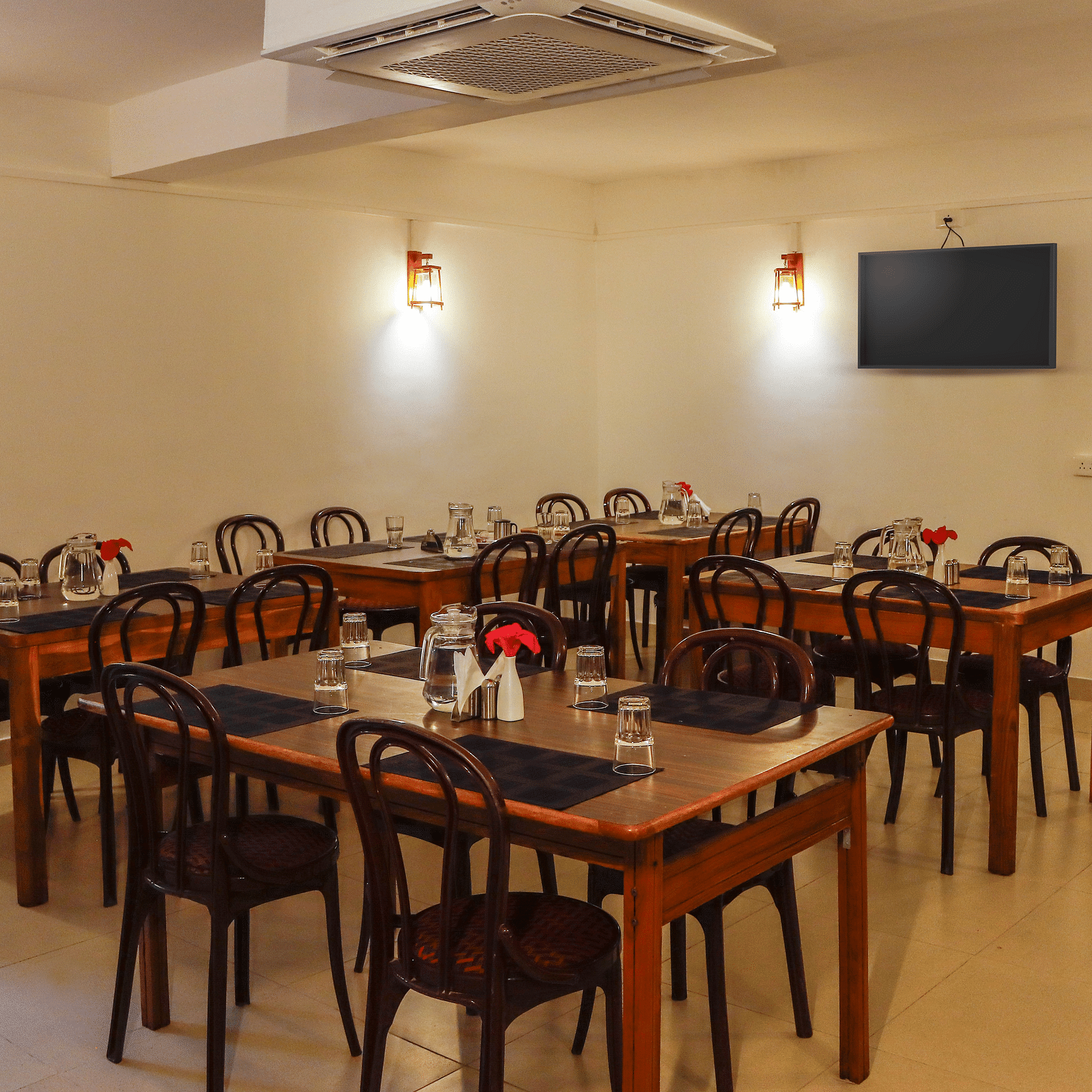 A dining setting of a restaurant at Hotel Vinayaga, Tiruppur.