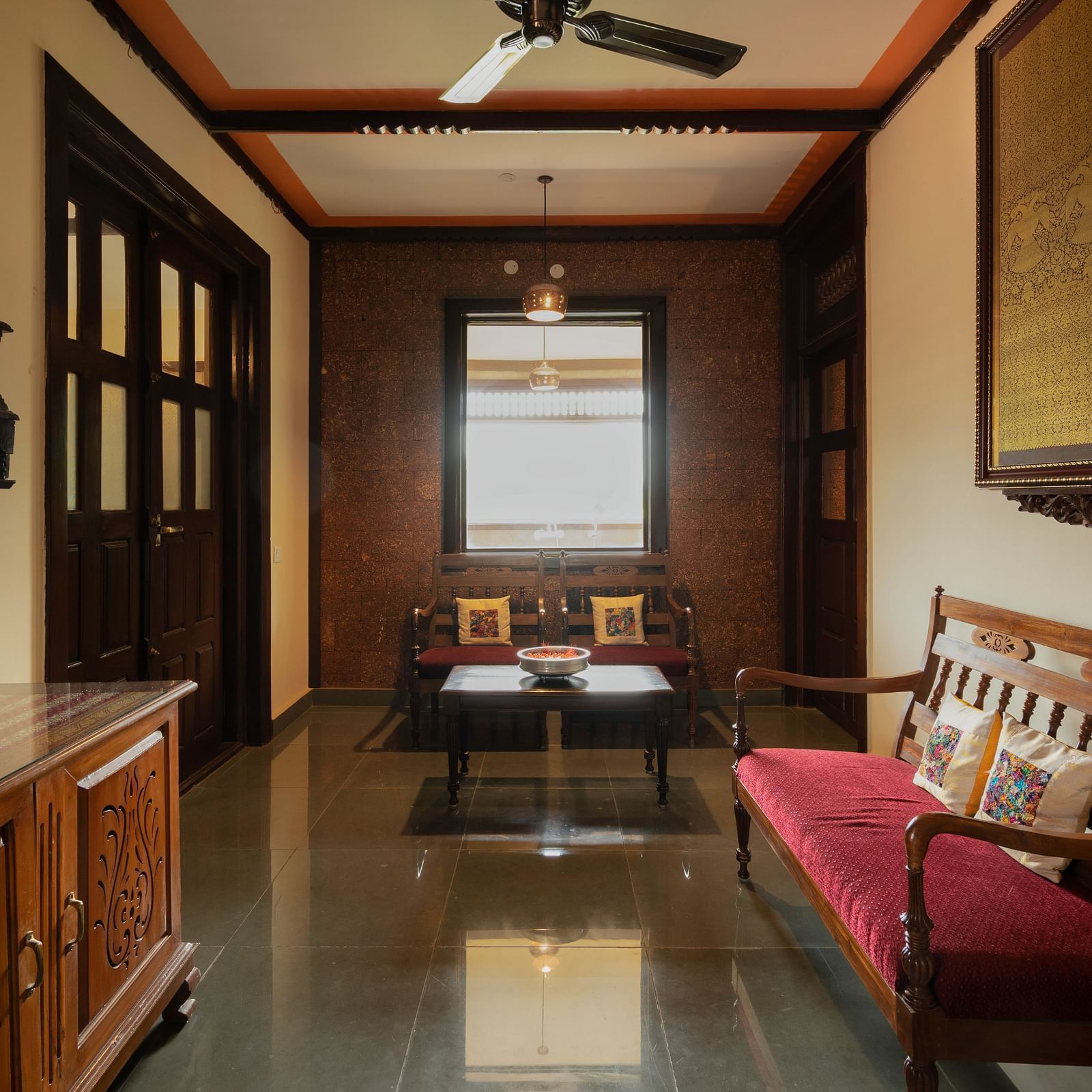 An image of a seating area which also has a cabinet, tables, and other wooden furnishes - Hoysala Village Resort, Hassan