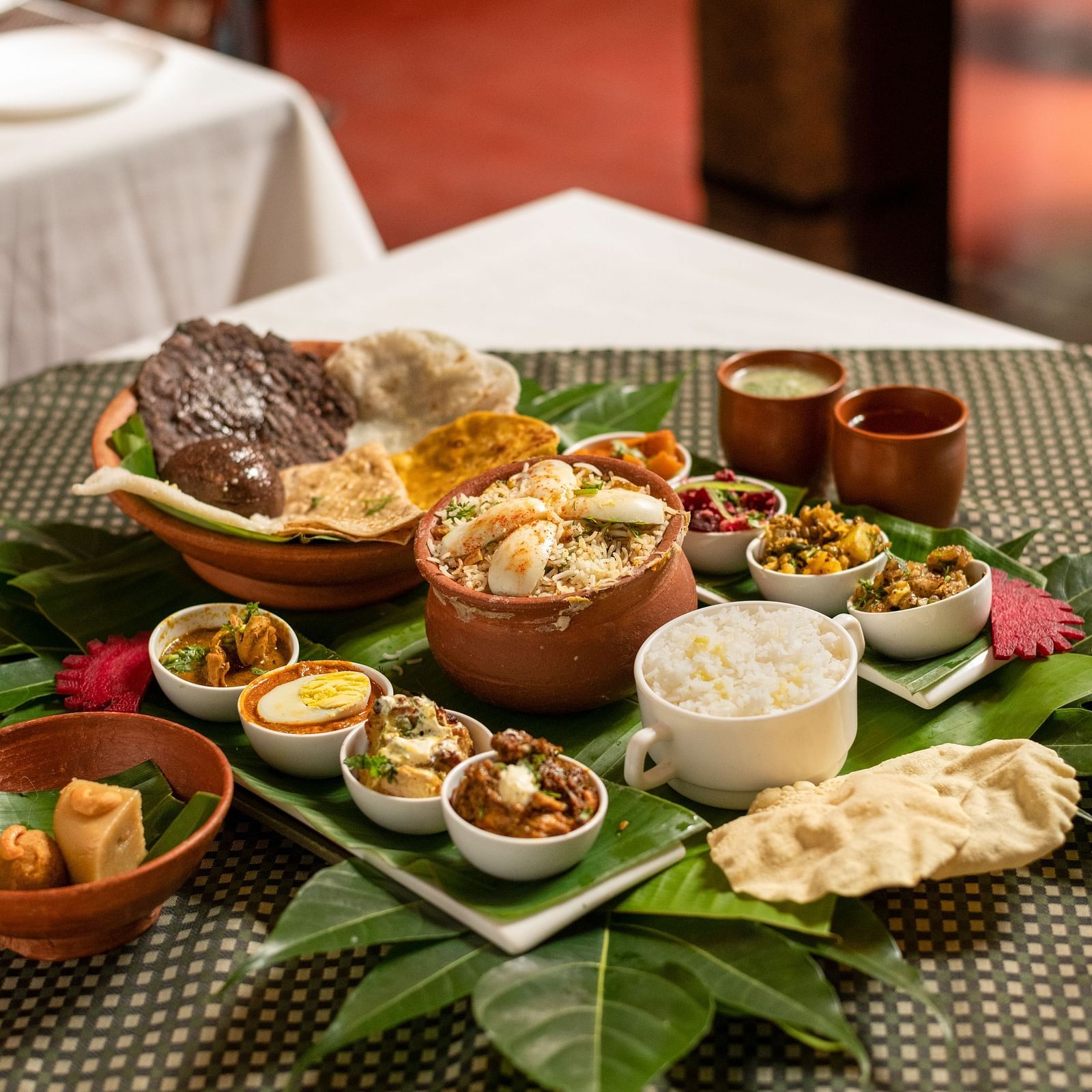 image of a full platter of food served on plantain leaves at Hoysala Village Resort, Hassan
