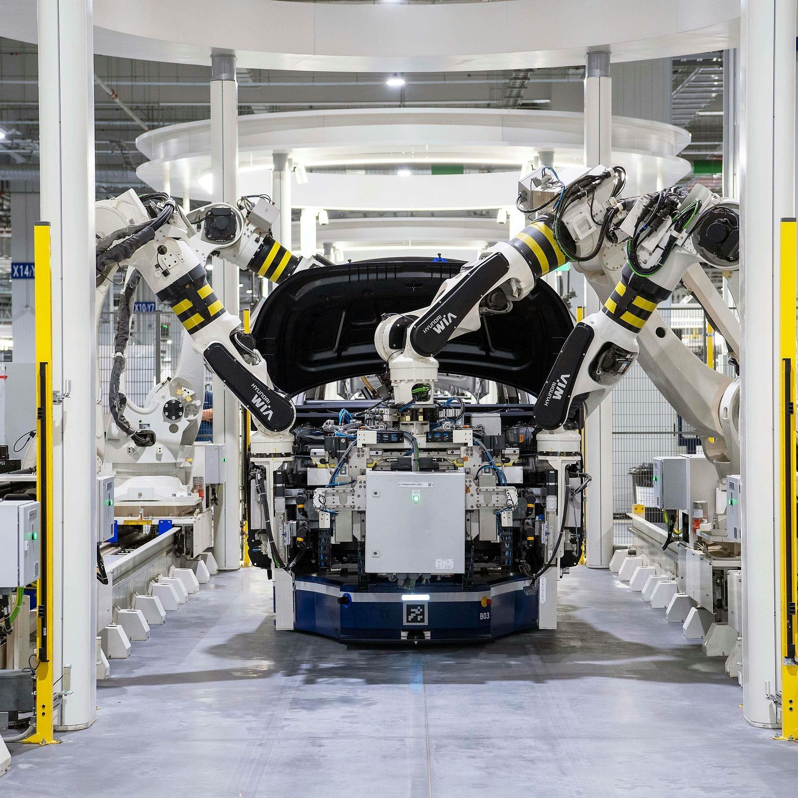 An advanced automotive manufacturing line featuring robotic arms assembling a vehicle.