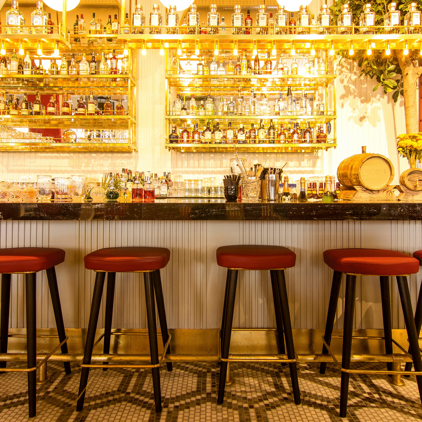 A bar showcasing a variety of drinks arranged on the shelves.
