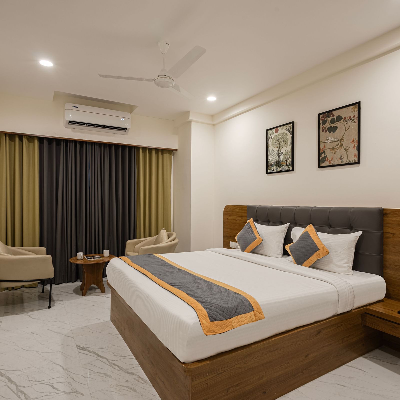Comfortable room with bright curtains, bed, and wall art at Lemonridge Hotels, IDPL Balanagar.
