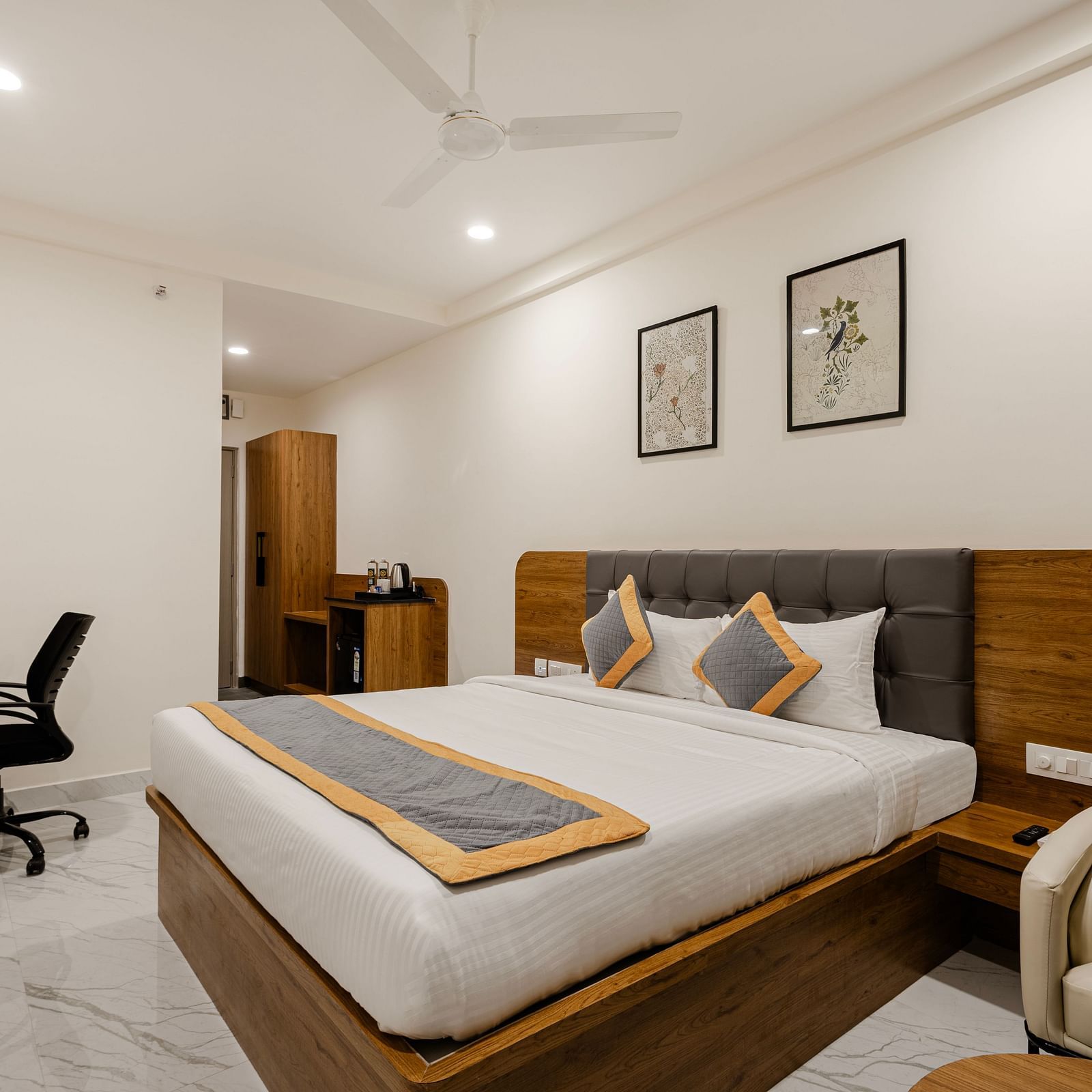 A corner view of cosy bedroom with sleek interiors at Lemonridge Hotels, IDPL Balanagar
