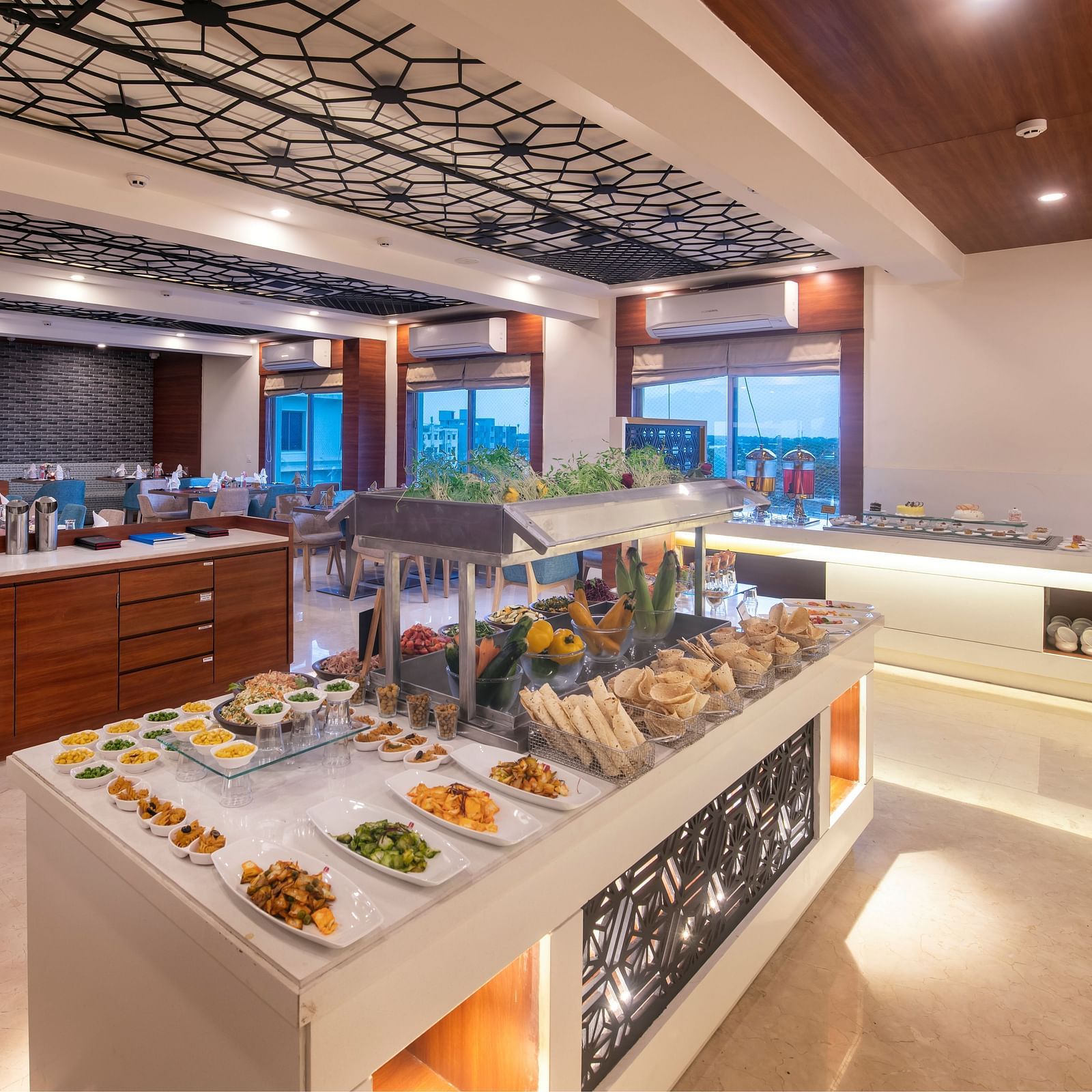 Restaurant buffet spread showcasing a variety of dishes on modern counters at Lords Eco Inn Shapar Rajkot