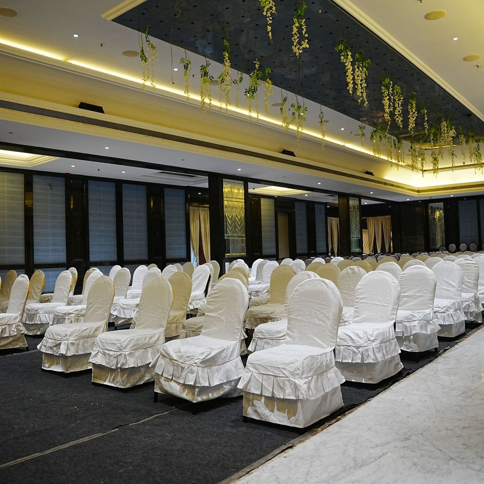 a corner view of the banquet hall with theatre style seating arrangement at Lords Hrim Akshara Resort Basar
