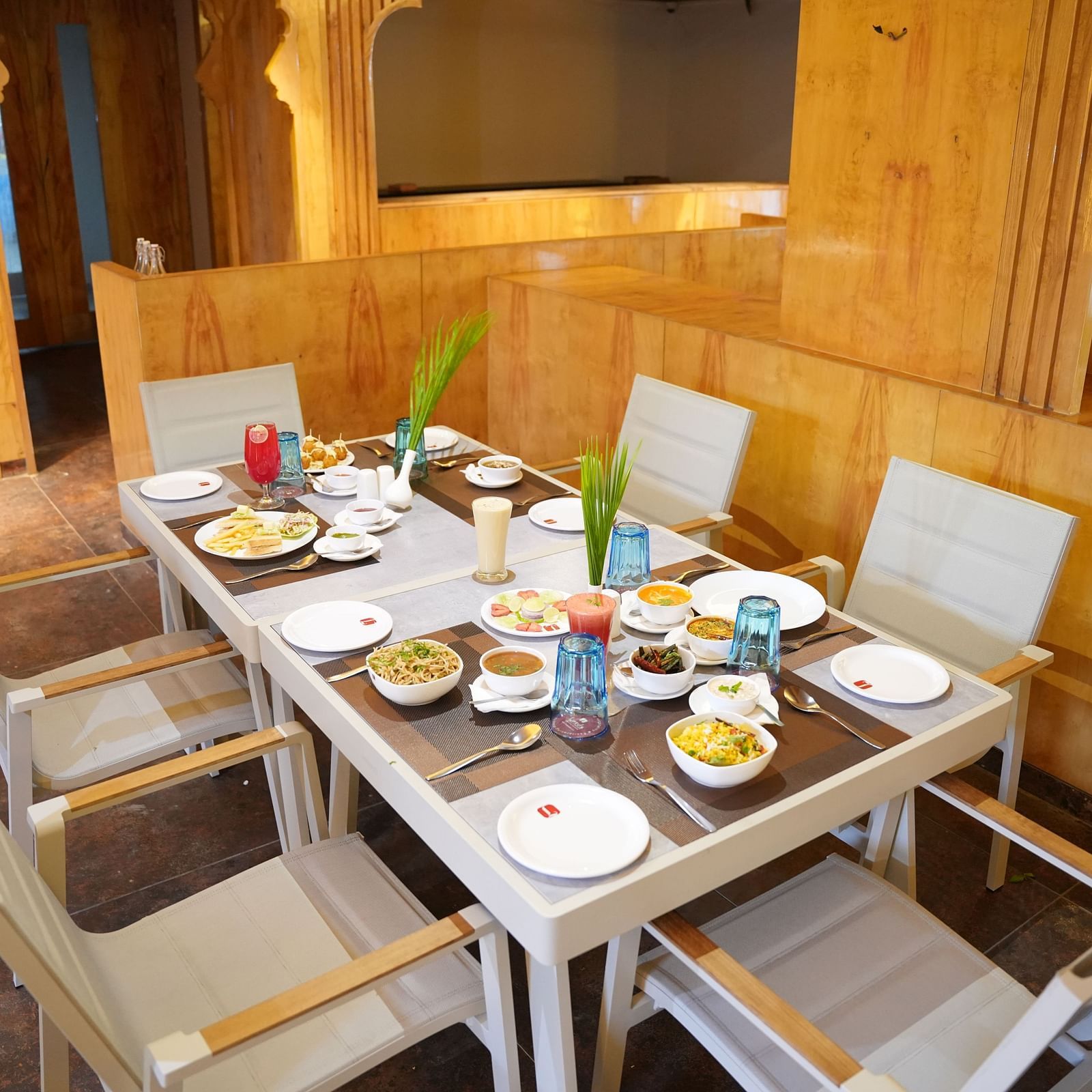 a six seater table with plates, glass, and cutlery in a wooden themed restaurant at Lords Hrim Resort Basar 