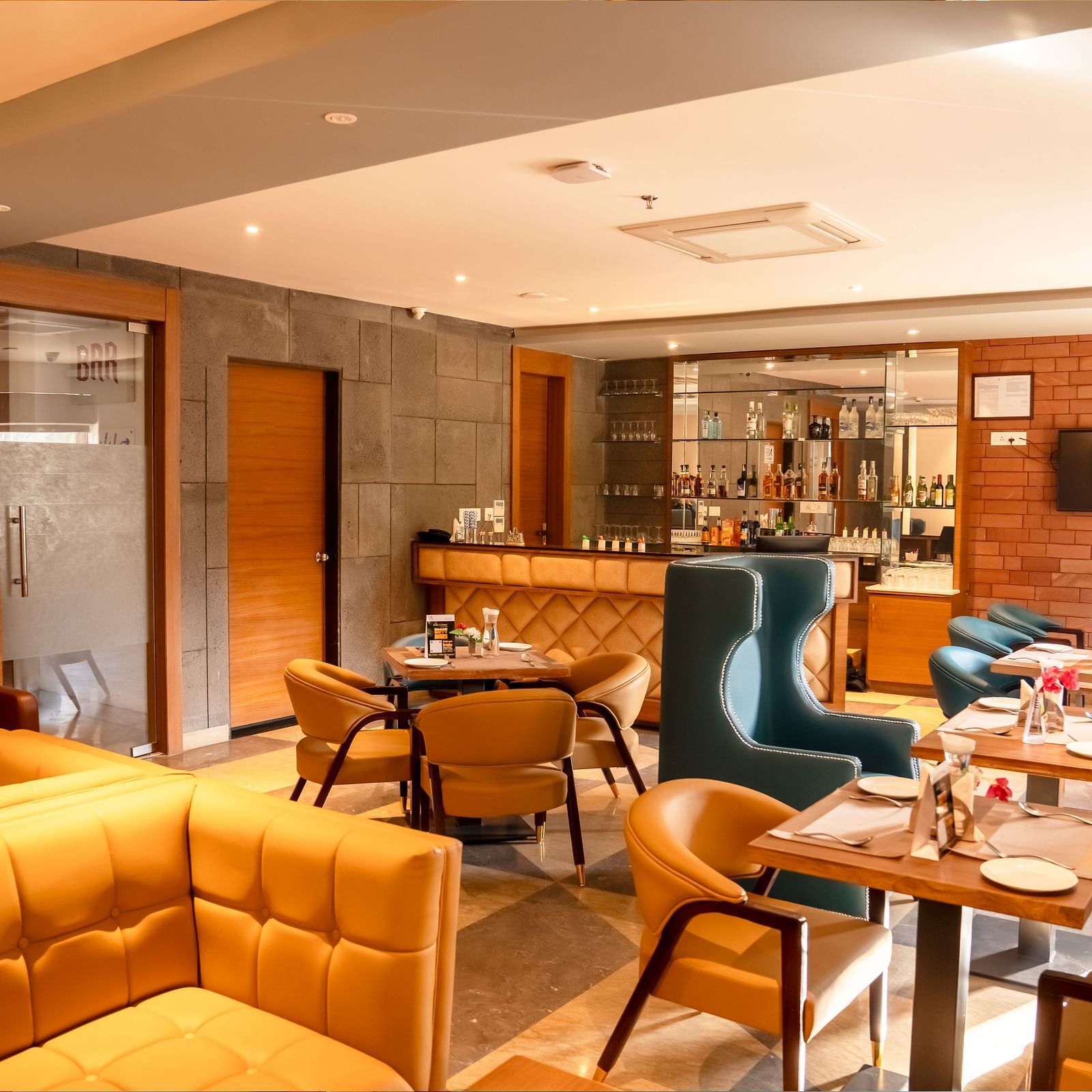 The Lords Inn Udaipur features a stylish dining area with a bar, comfortable seating, and modern decor.