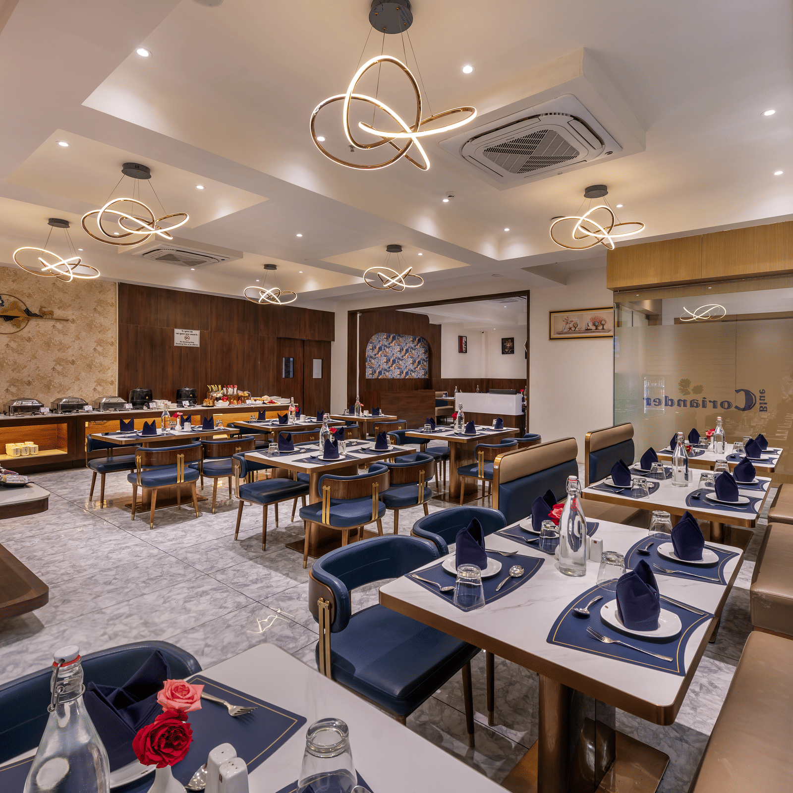 In-house dining area with neatly arranged tables and bright interiors at Lords Studio Inn, Jamnagar.