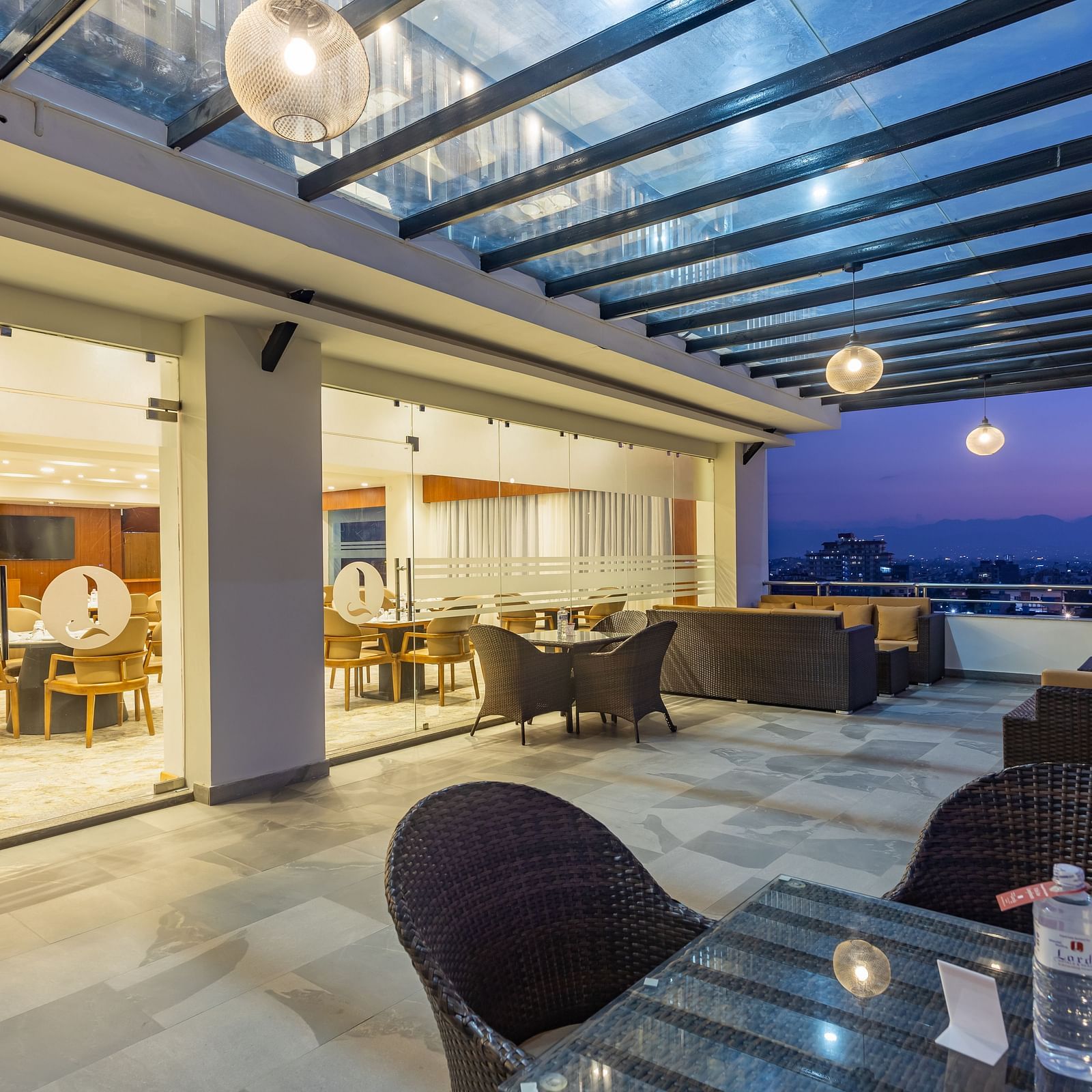 Outdoor seating arrangement at Mandala by Lords featuring a spacious corridor with a covered ceiling and picturesque views.