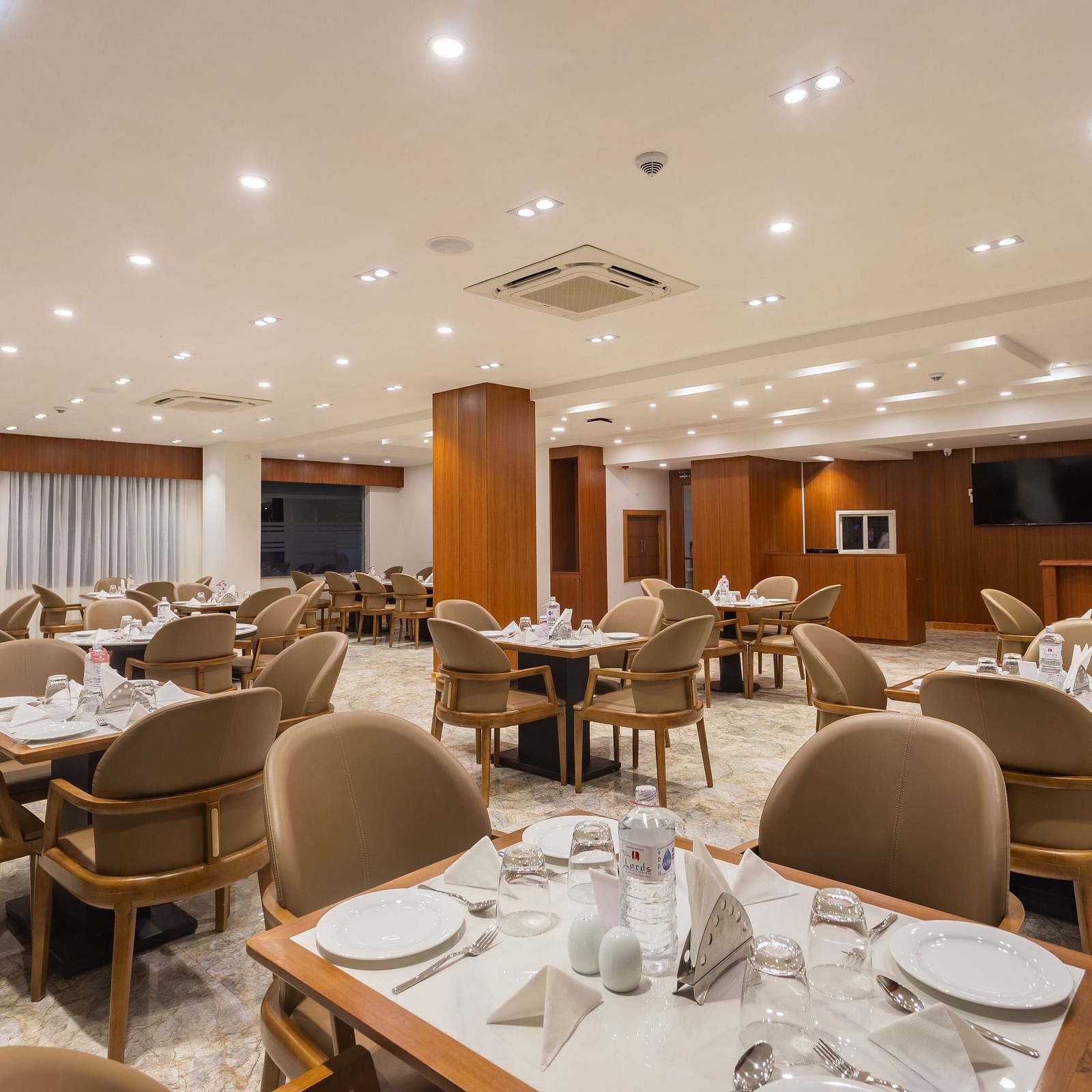 Close view of The Blue Coriander restaurant at Mandala Norling Lords Prime in Kathmandu featuring a fine dining seating arrangement and well-placed cutlery.