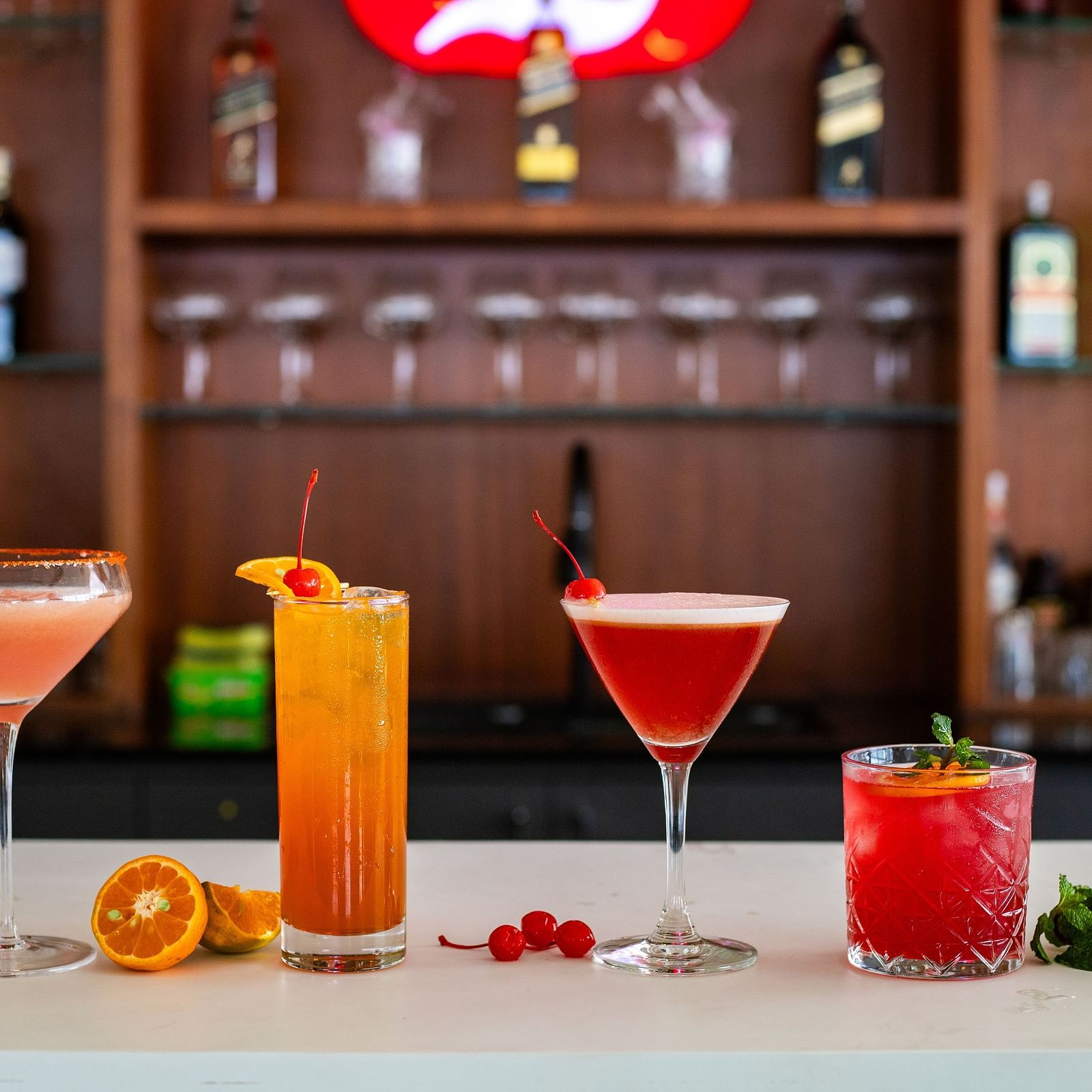 Four vibrant looking drinks with decoratives placed on a counter-top at Mandala Norling Lords Prime in Kathmandu.