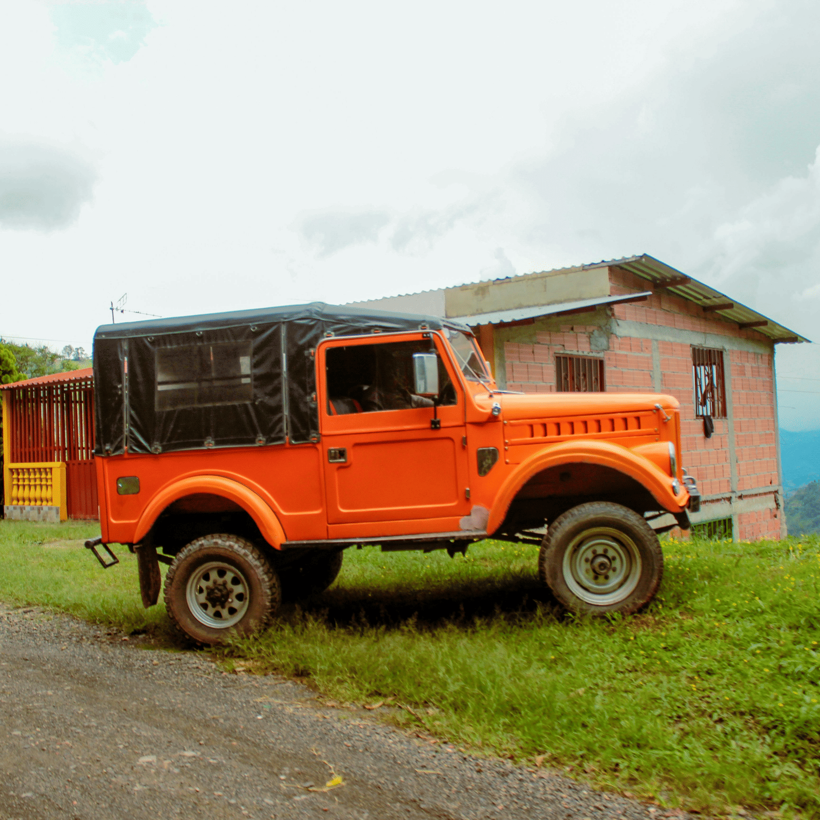 View of the landscape seen behind a car parked on grass.