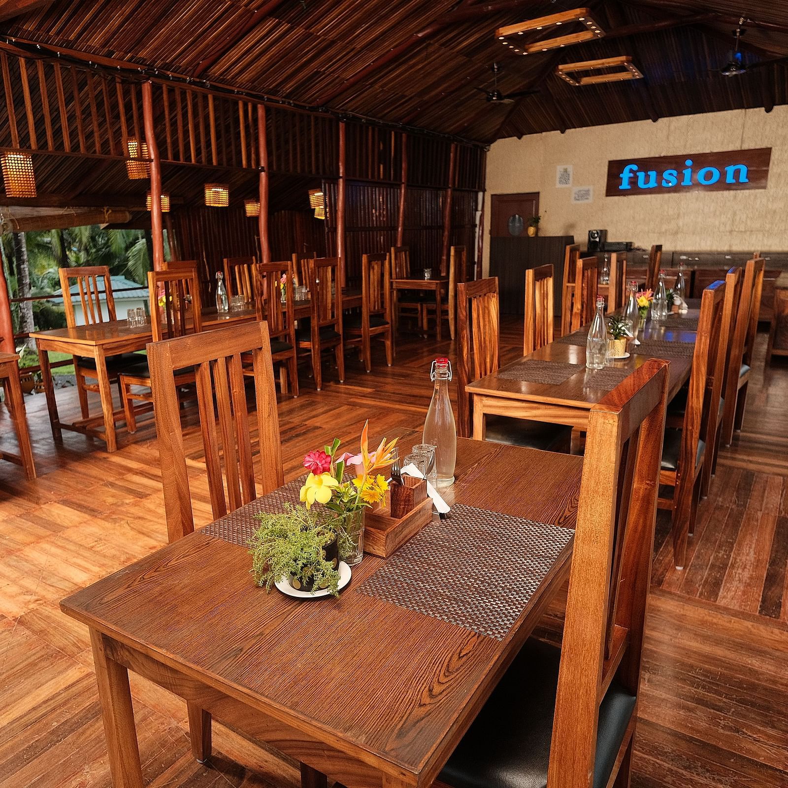 A wide shot of the restaurant's interior, displaying the layout of tables and seating areas | Fusion Cafe and Multi-cuisine | RainForest Resort, Port Blair, Andaman and Nicobar Island