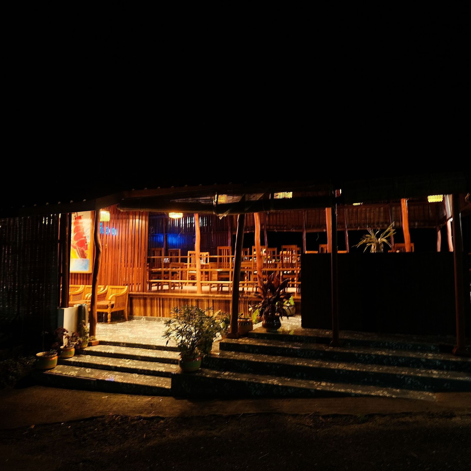 A dark, dimly lit restaurant interior is partially visible | Fusion Cafe and Multi-cuisine | RainForest Resort, Port Blair, Andaman and Nicobar Island