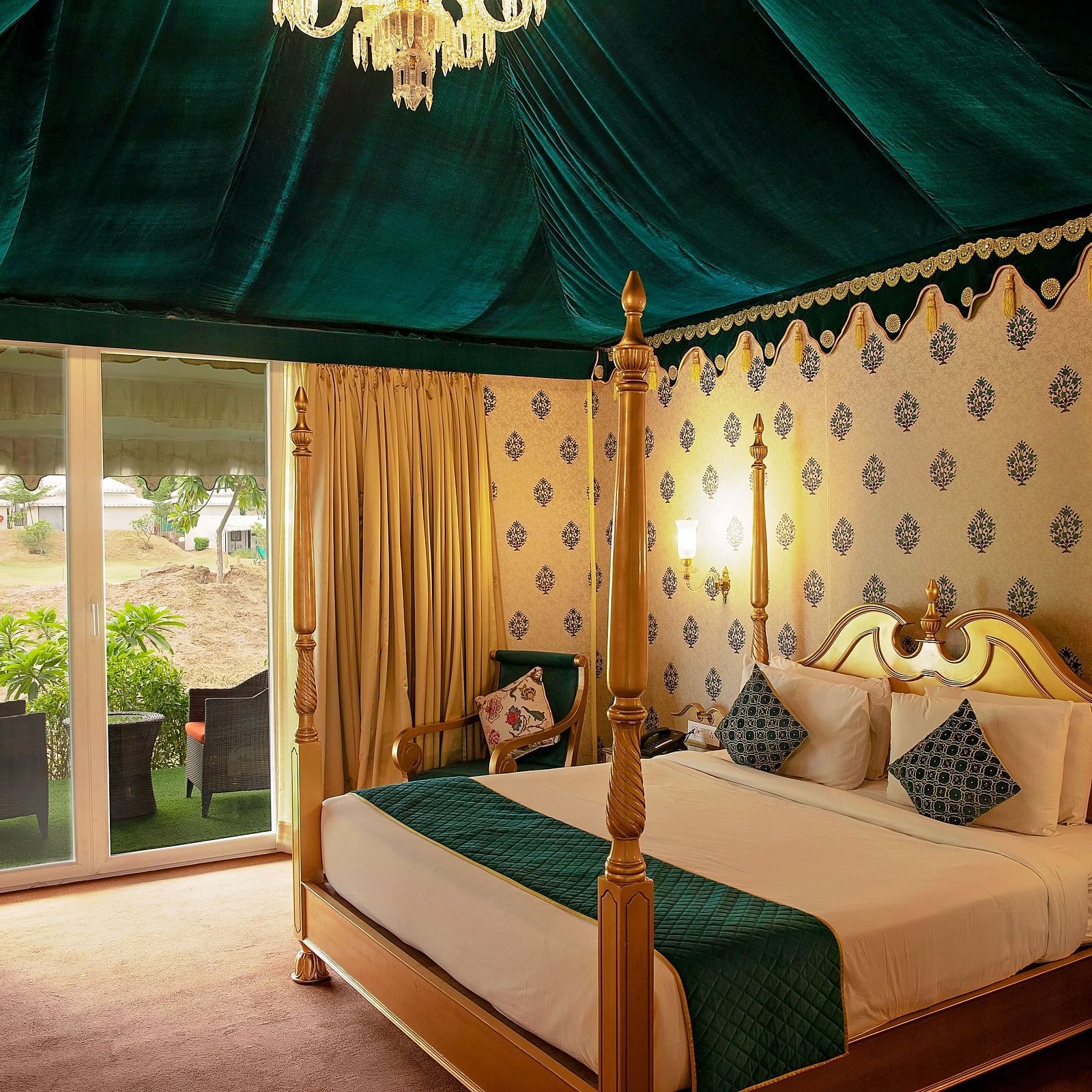 Image of Royal Luxury Tent a bed and an attached balcony on the side at Rajasthali Resort & Spa Jaipur.