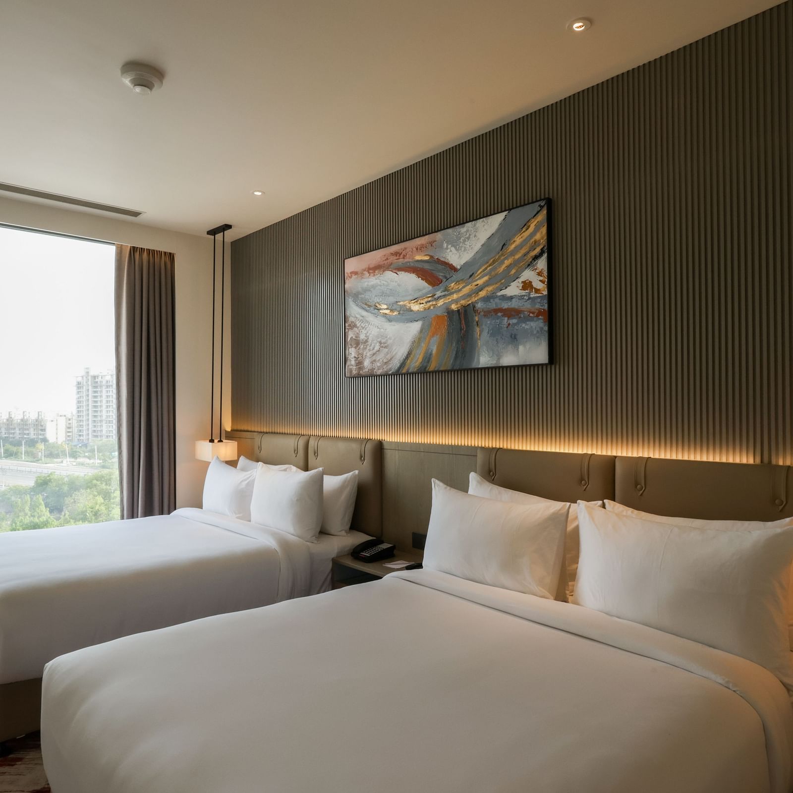 Twin room with large windows and outdoor view at Ramada by Wyndham Sonipat Murthal