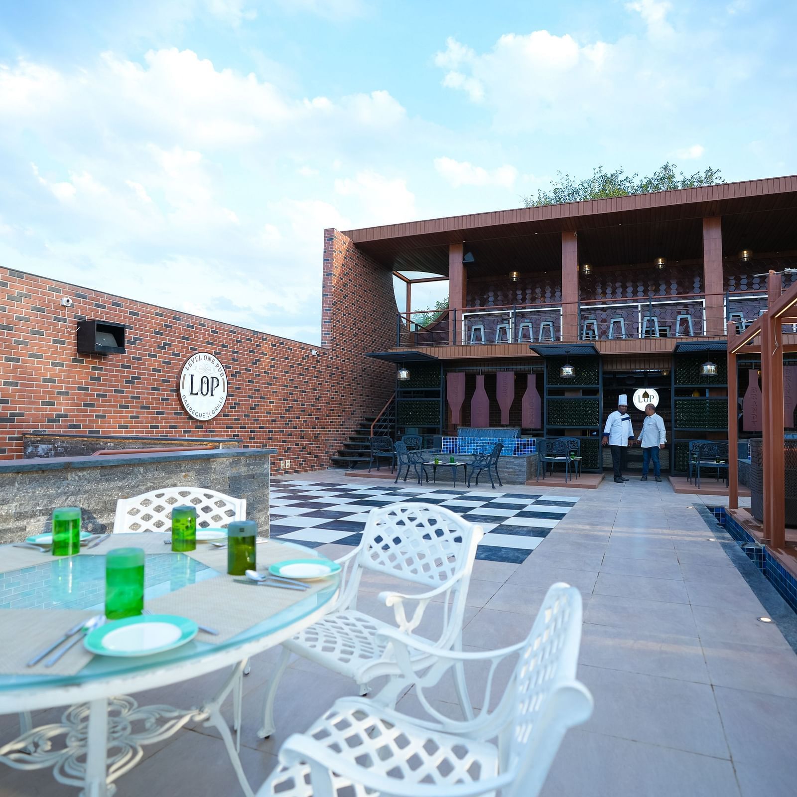 Side view of the open dining area with seating arrangements at Sathyam Grand Hotels