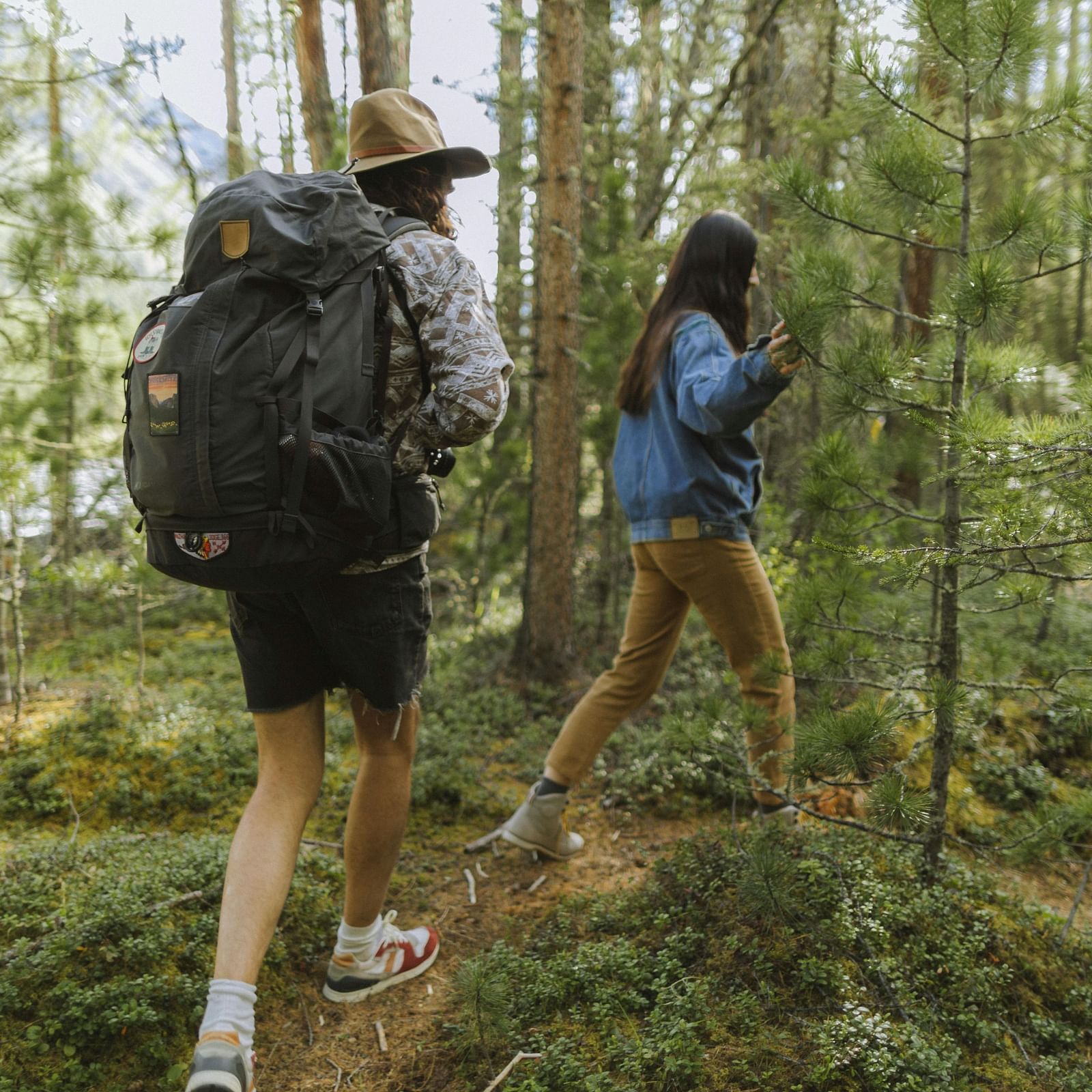 Two people trekking in a forest