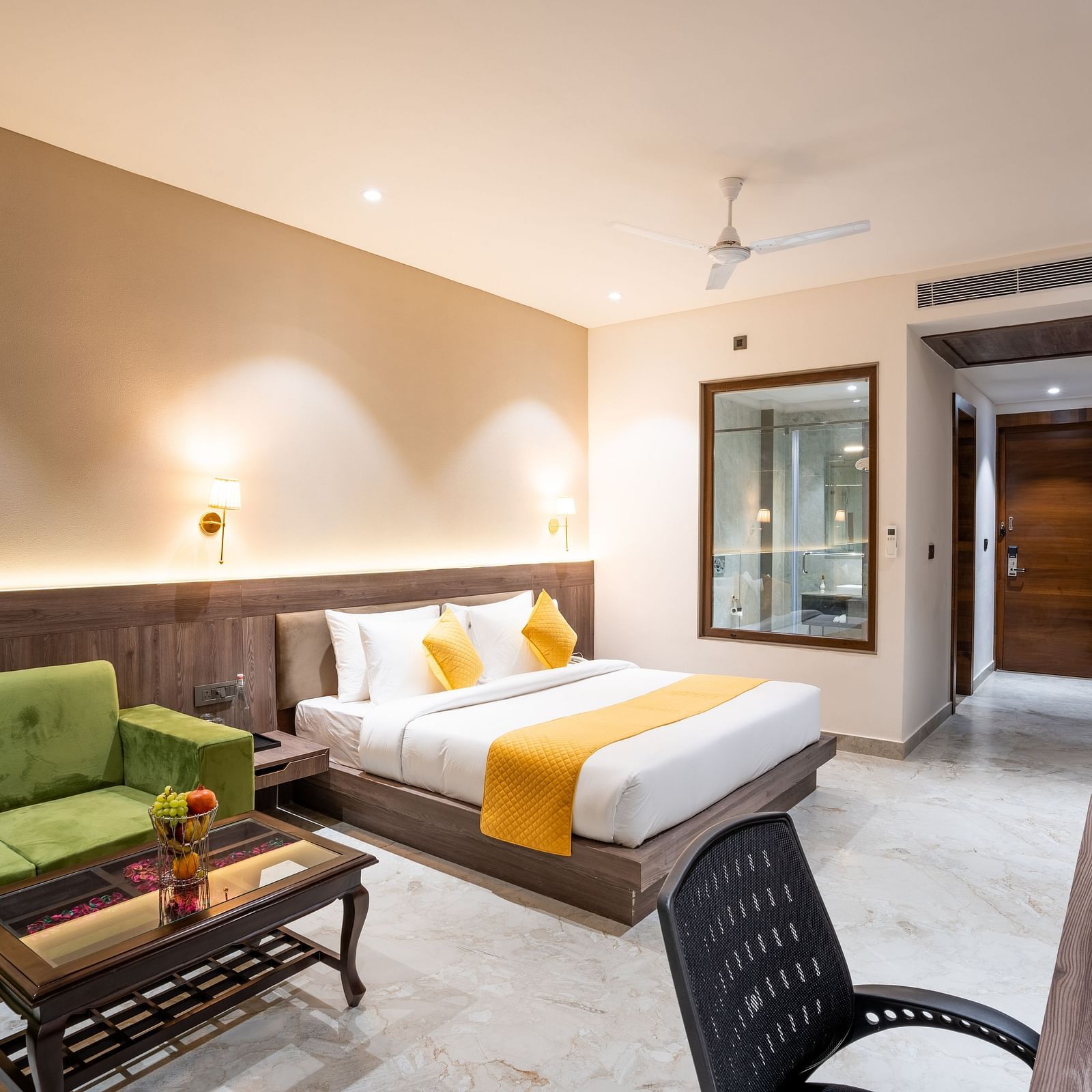 A premium room with a large bed, green sofas, a coffee table and a work desk - Shervani Pebbles & Pines, Corbett