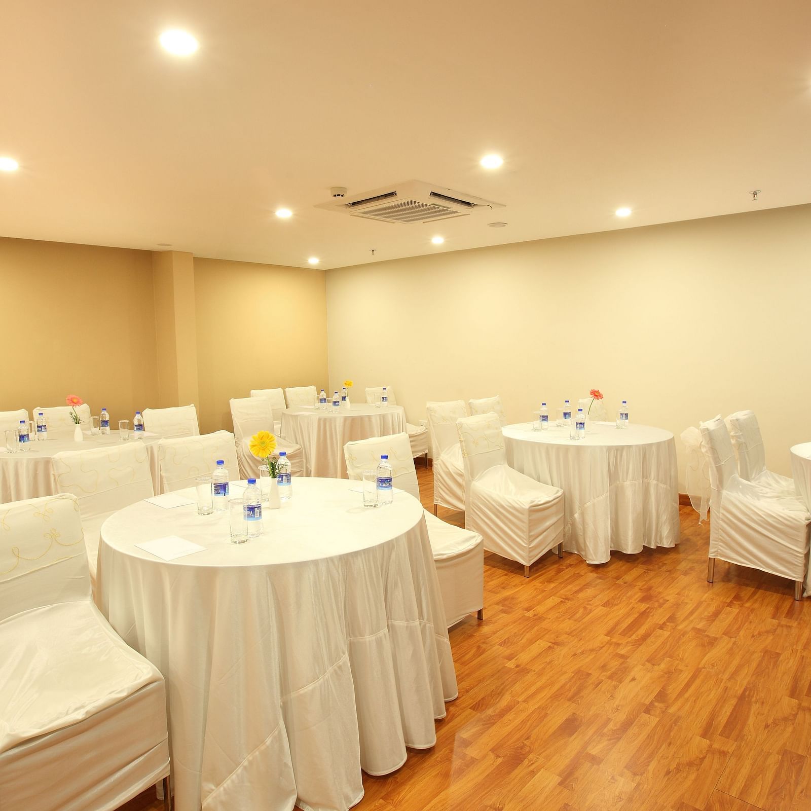 Round table seating inside the Banquet - Starlit Suites, Kochi