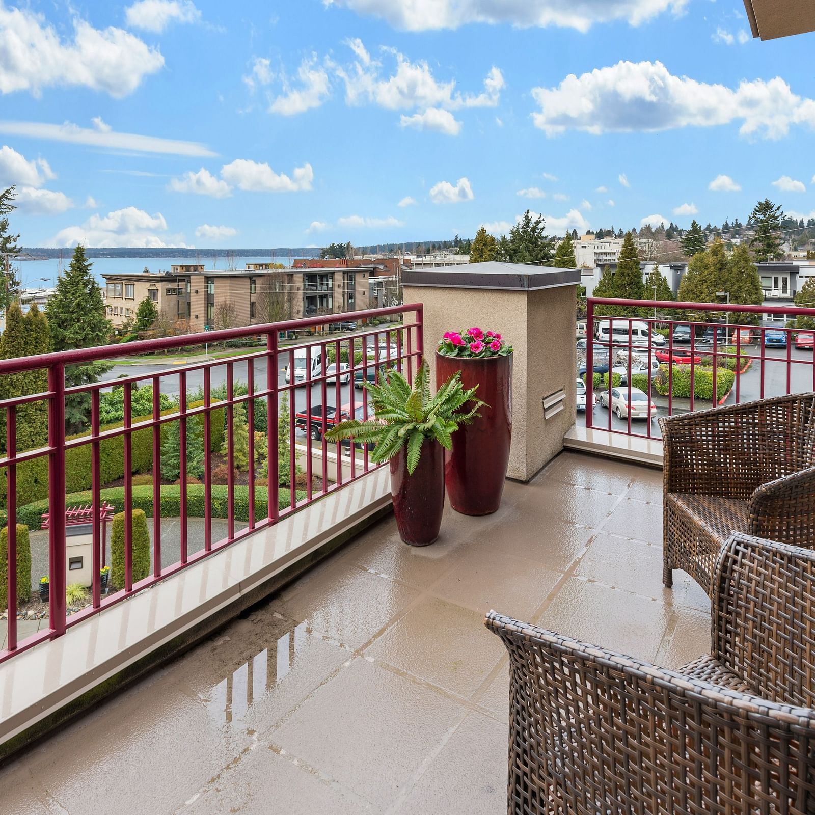 an overview of a balcony with seats on it and views of the city from it
