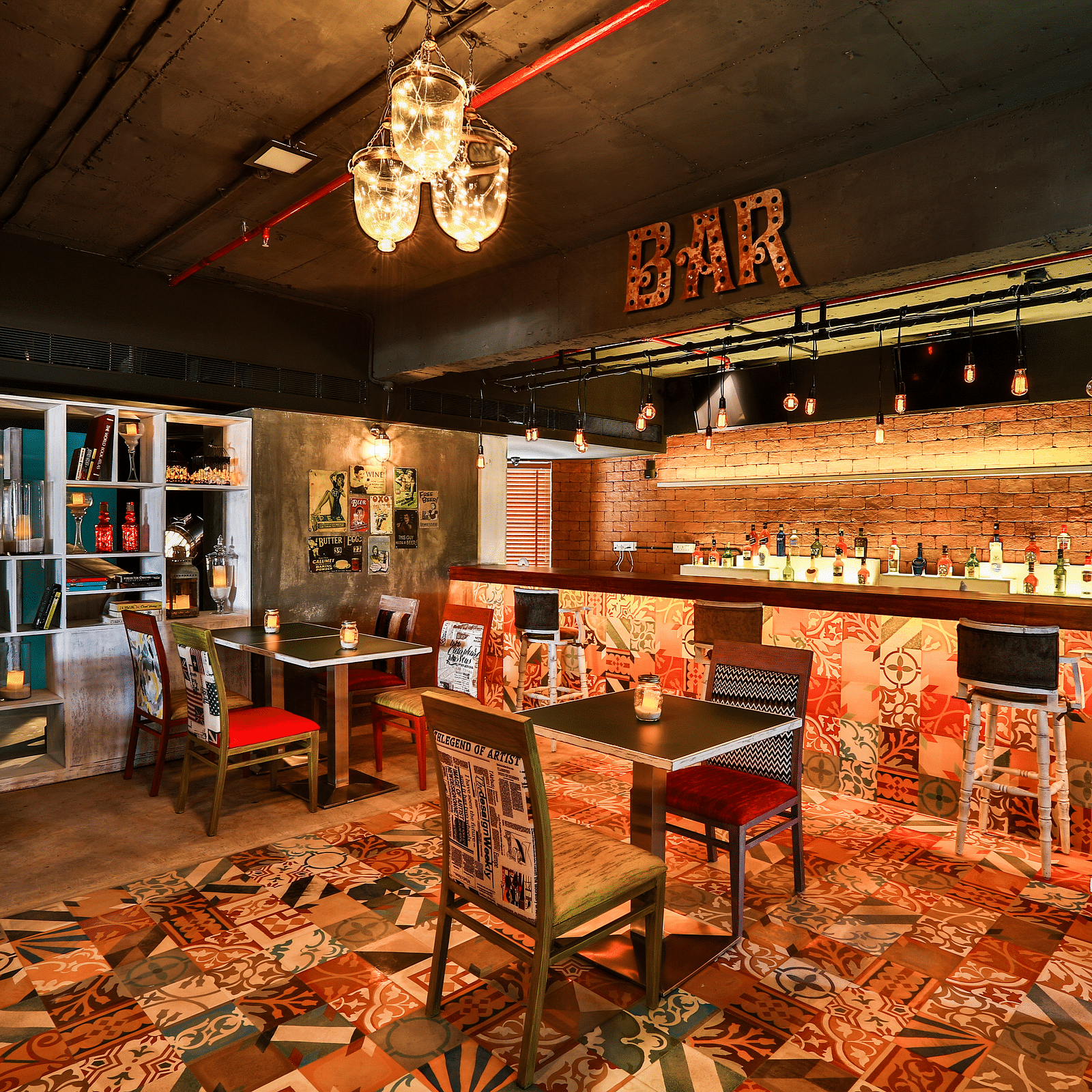 Indoor seating in the restaurant at T24 Residency, Andheri East, Mumbai with a bar counter in the backdrop