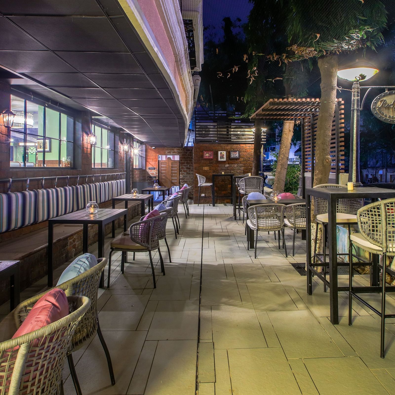 A cosy outdoor seating area with tables and chairs, perfect for enjoying a drink under the stars  | T24 Retro