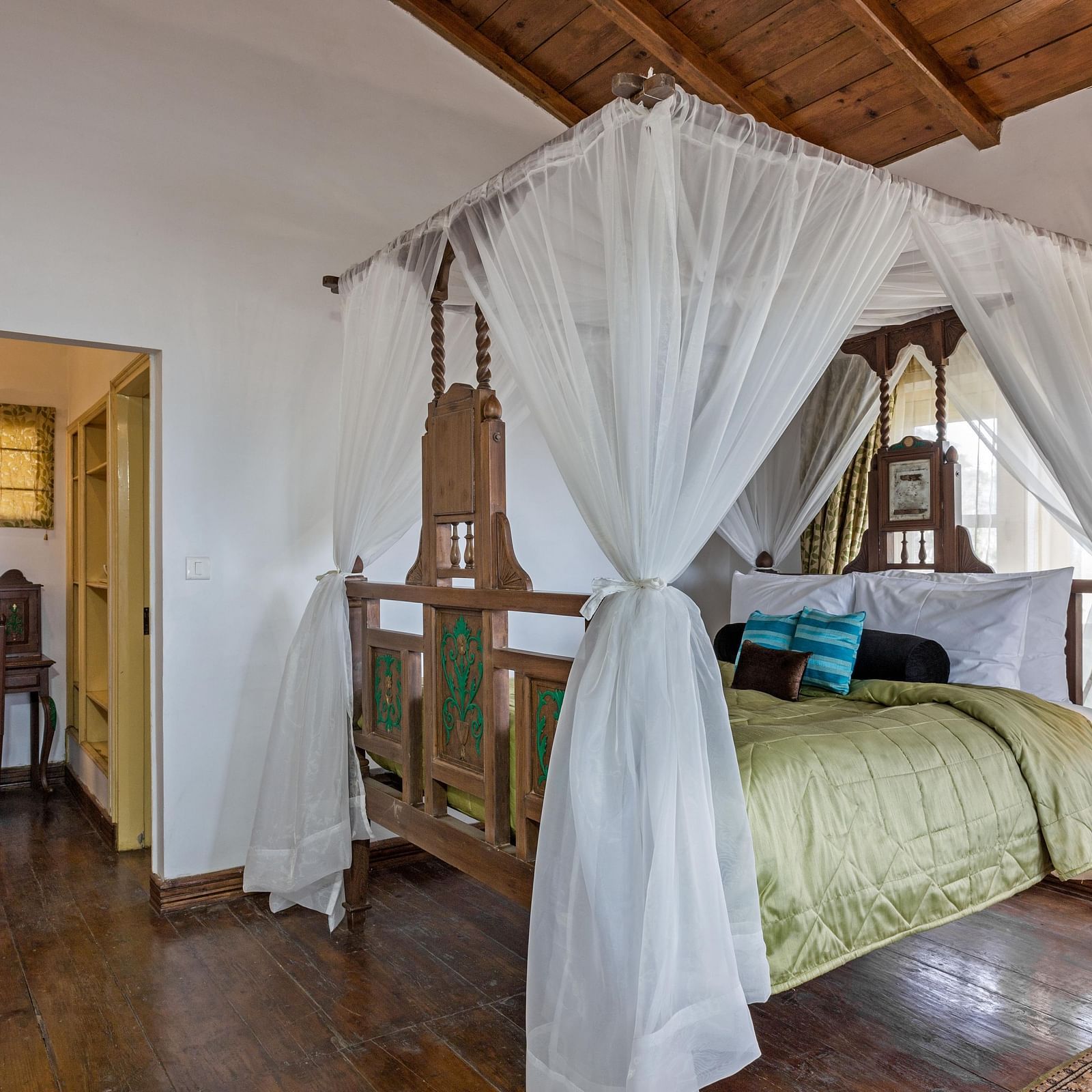 Bed with side canopy and a lamp on the side of the bed at 3 bhk cottage at Te Aroha by Shervani Mukteshwar