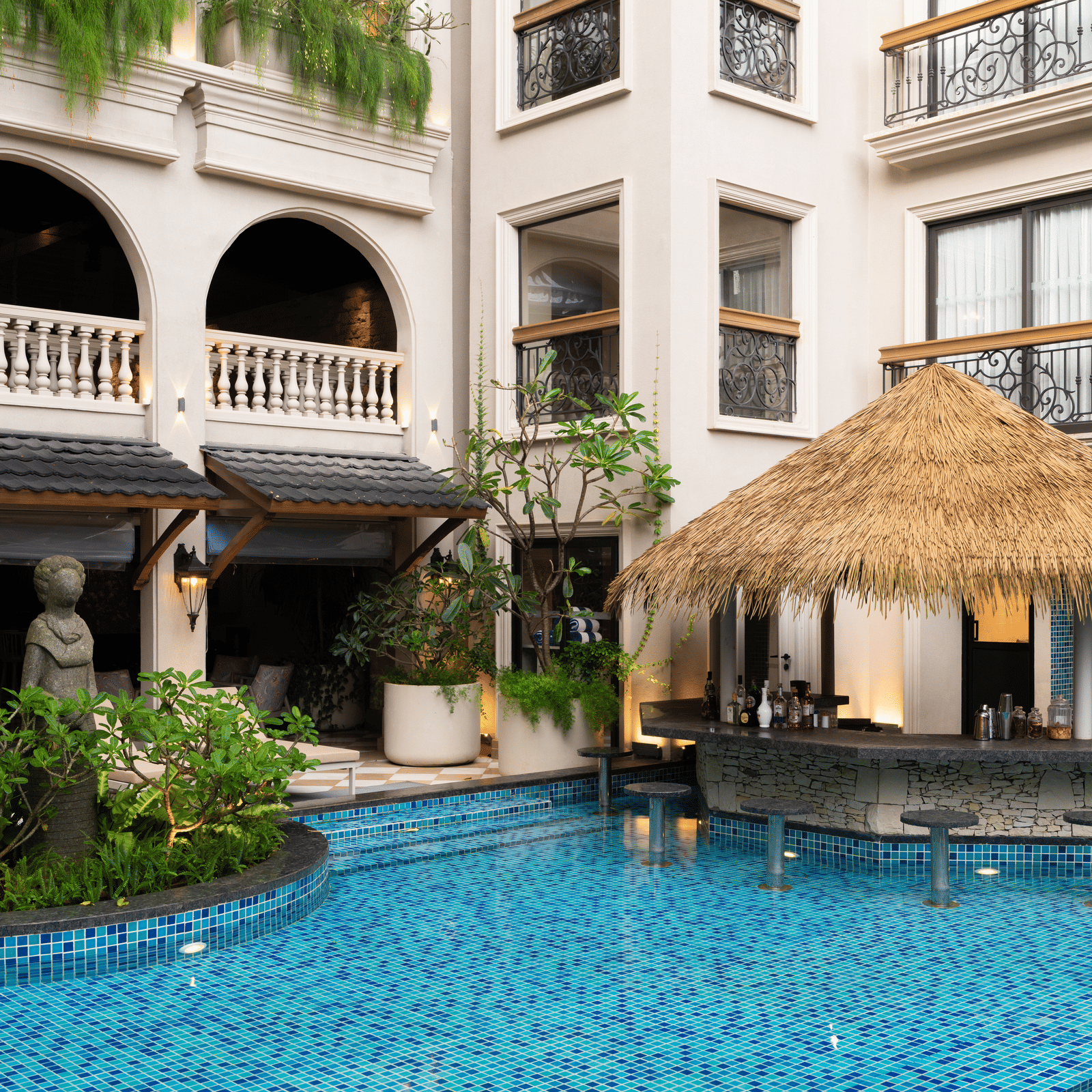 Side-view shot of the Splash Pool Bar with thatched roof above it at The Evren, Vagator.