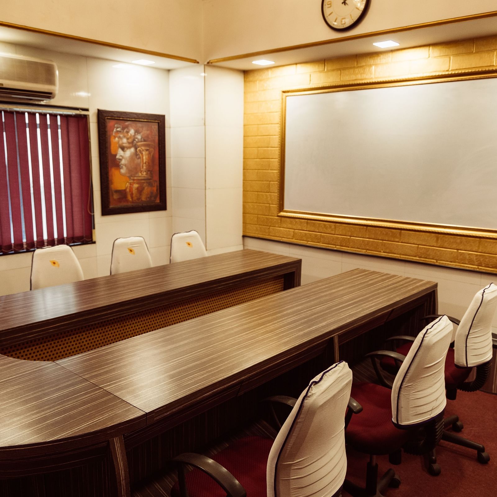 image of the boardroom at The Grand Krishna Rooms featuring a projector screen in far end of the room