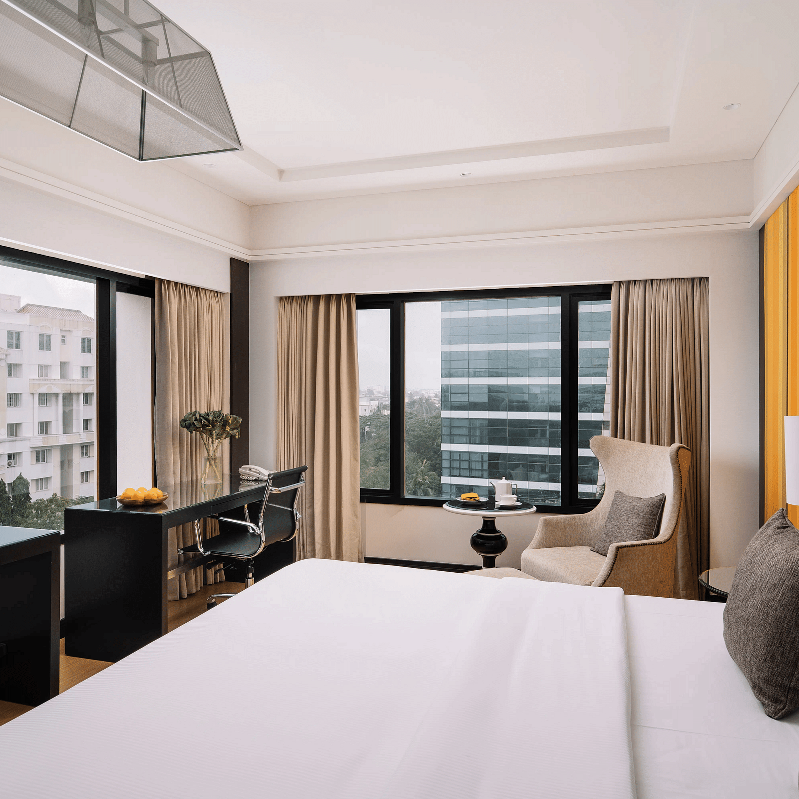 Image of Deluxe Room at The Raintree St. Mary s Road with a bed and a sofa