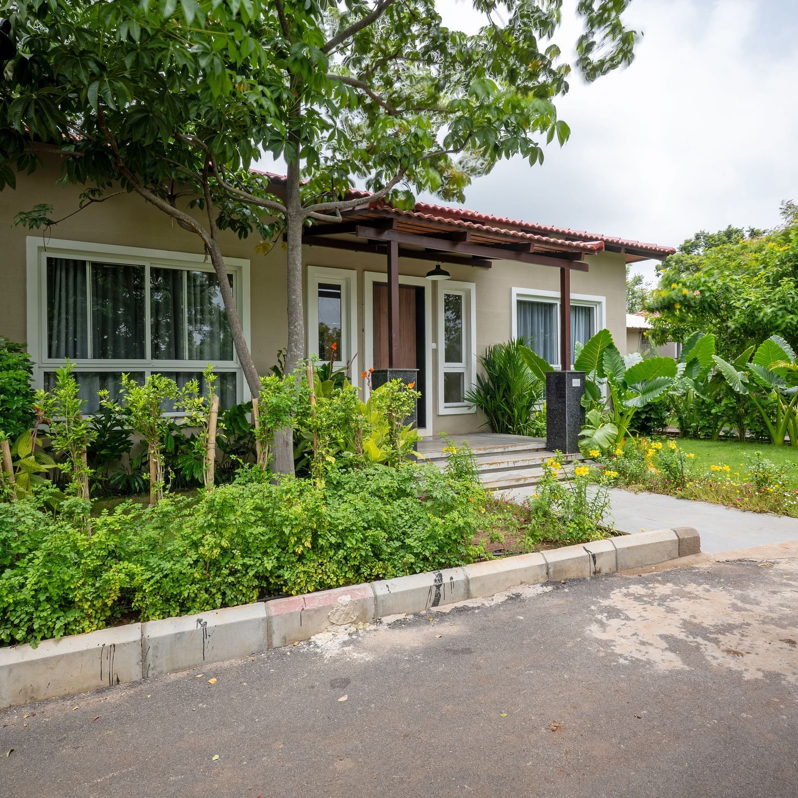 Front view of Ananta Villa – 3-Bedroom Villa at Trance Veechika Resort, Vikarabad, surrounded by a lush green landscape.