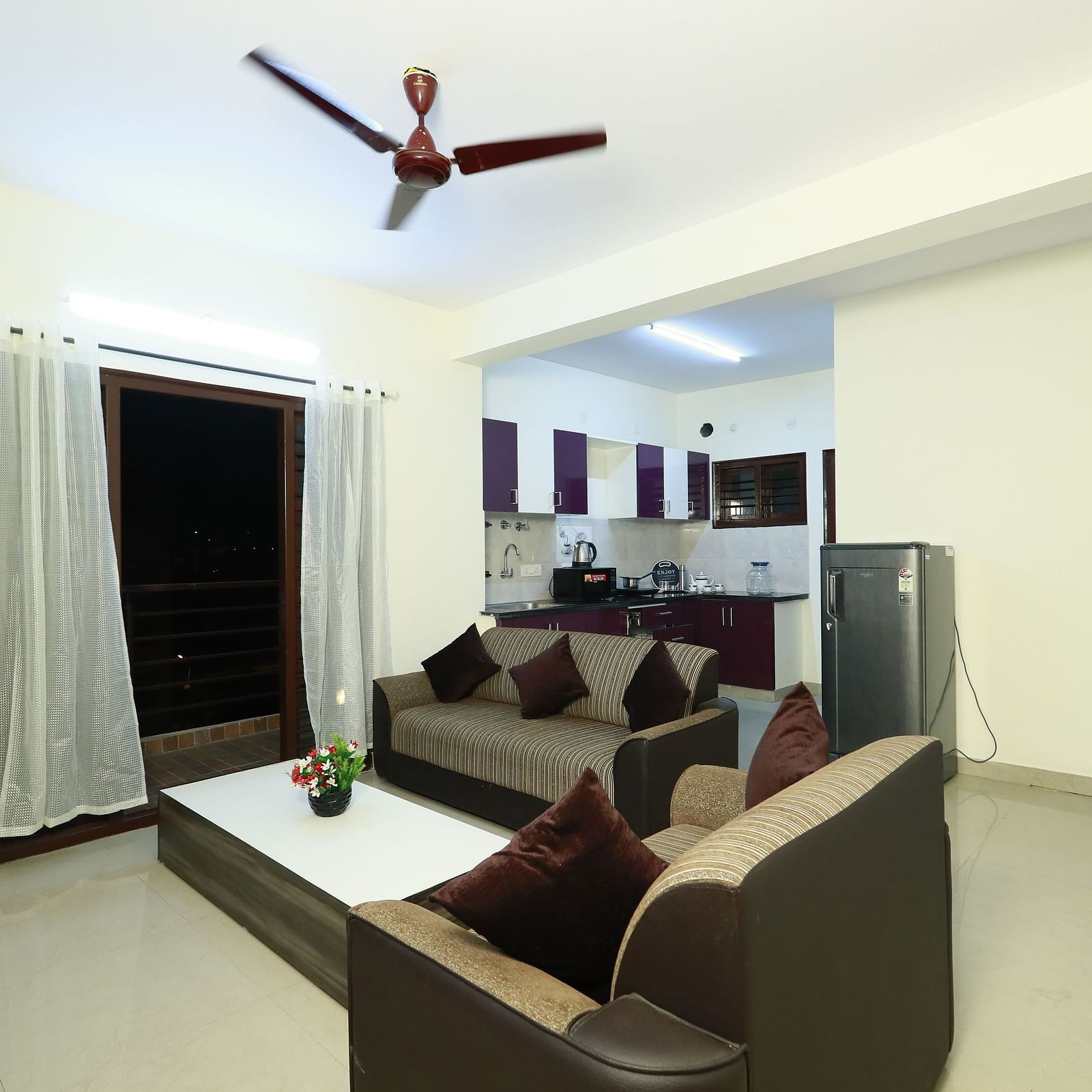 Living area with sofa seating and a coffee table at Tranquil ABS Orchid Serviced Apartments.