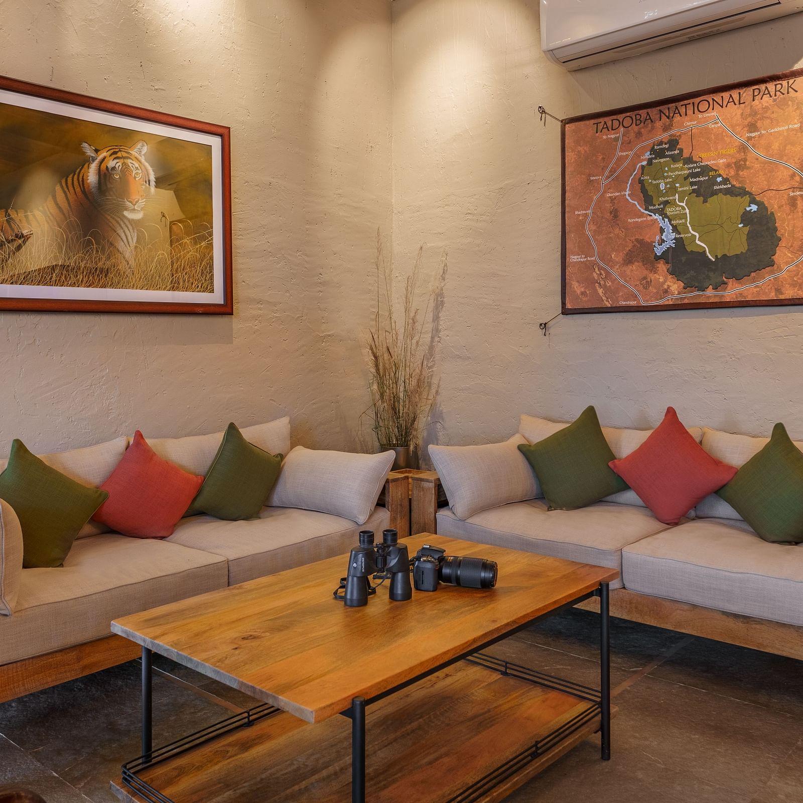 Cosy sofas and an armchair at the lounge at Trees N Tigers, Tadoba.