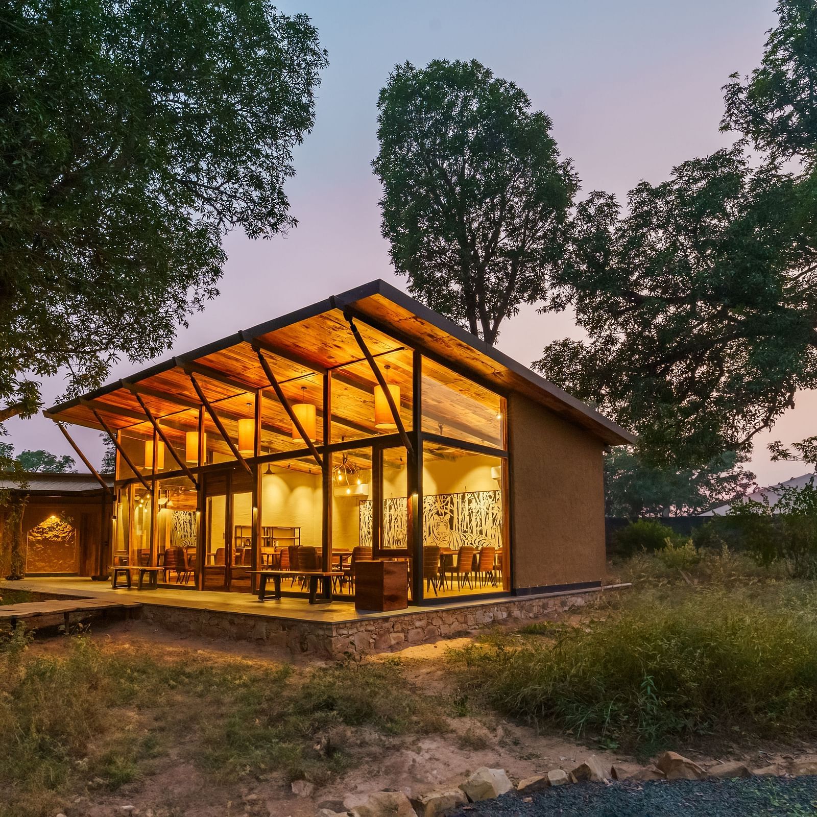 Facade view of a cottage at dusk at Trees N Tigers, Tadoba.