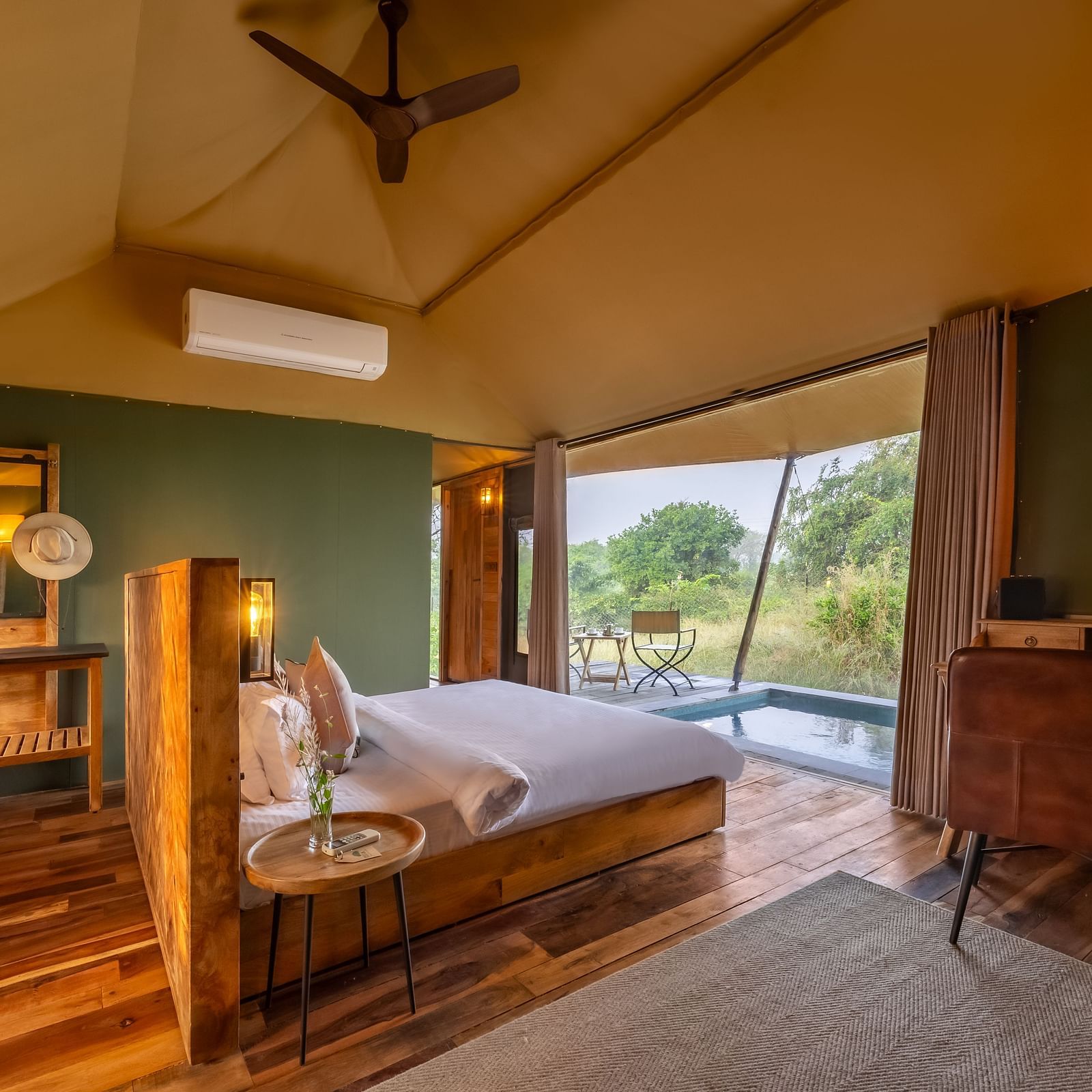 An interior of a room with double bed at Trees N Tigers, Tadoba.