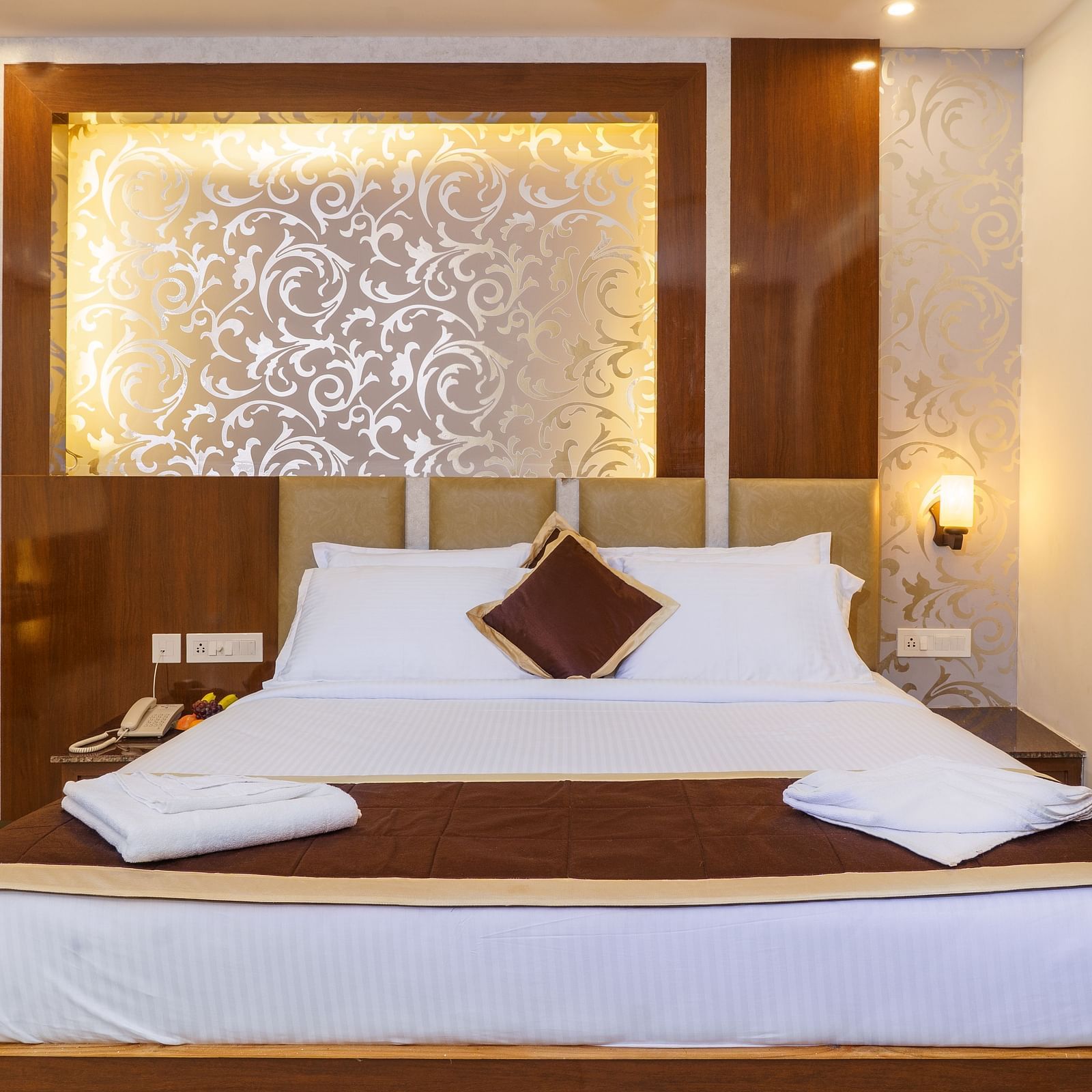 Deluxe room with bed and pillows at Wyt Hotels, Rameswaram