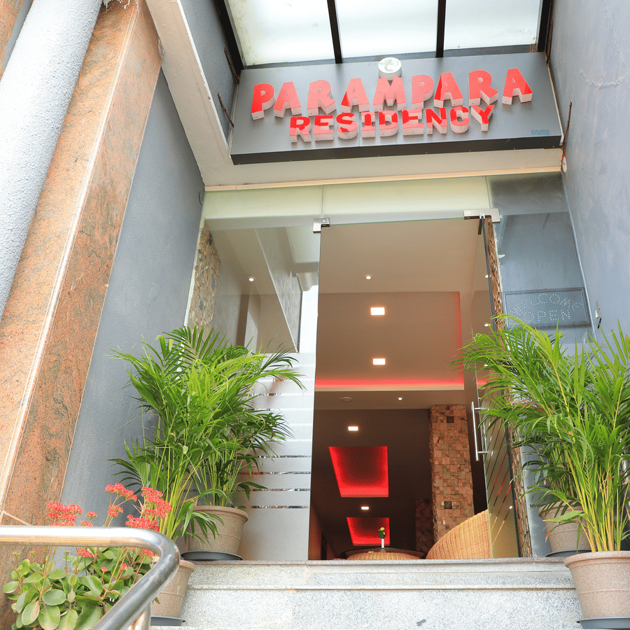 Facade of Parampara Residency, Kushalnagar Town with Parampara Residency written above the entrance.